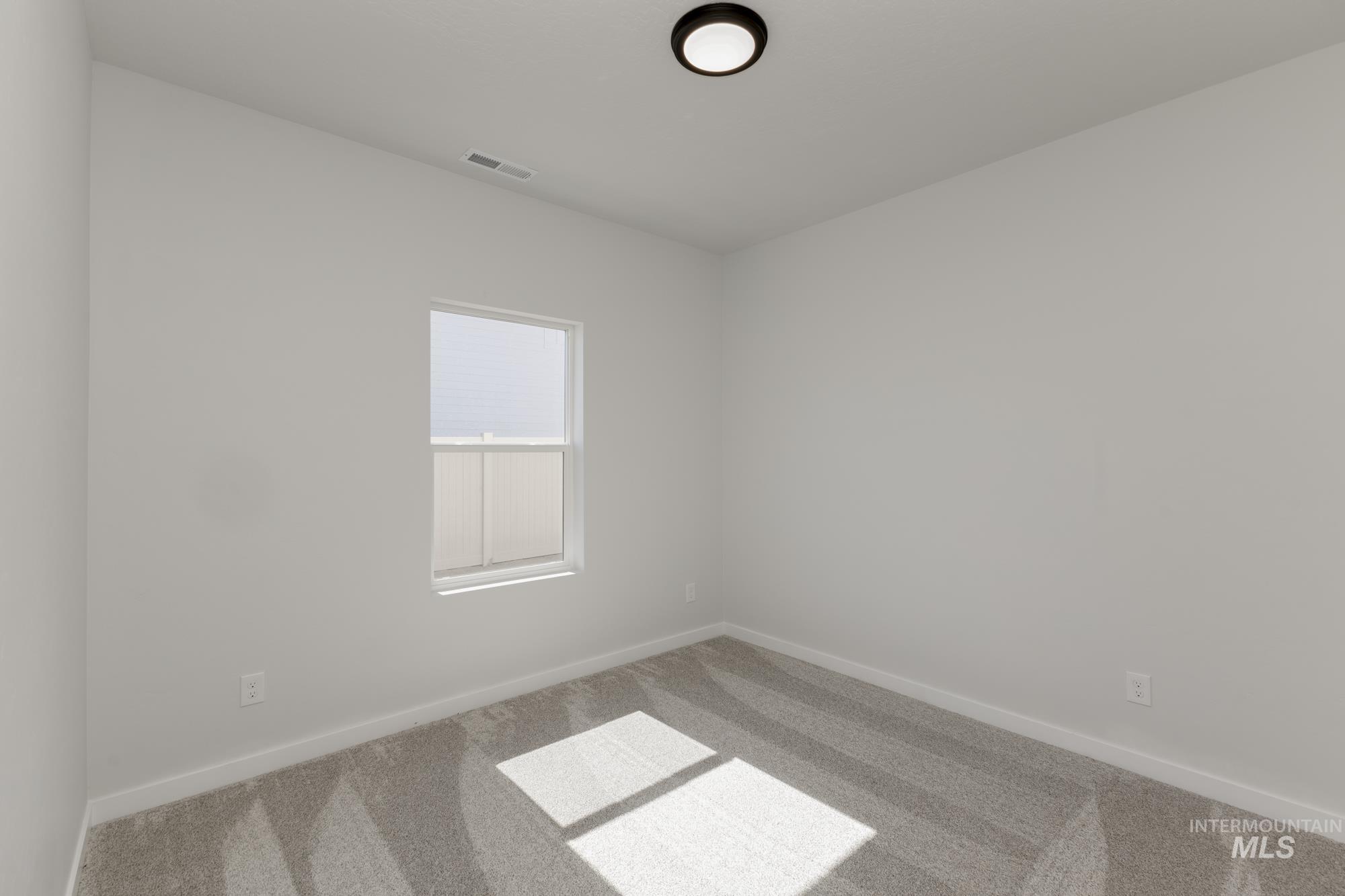 Empty room with carpet floors
