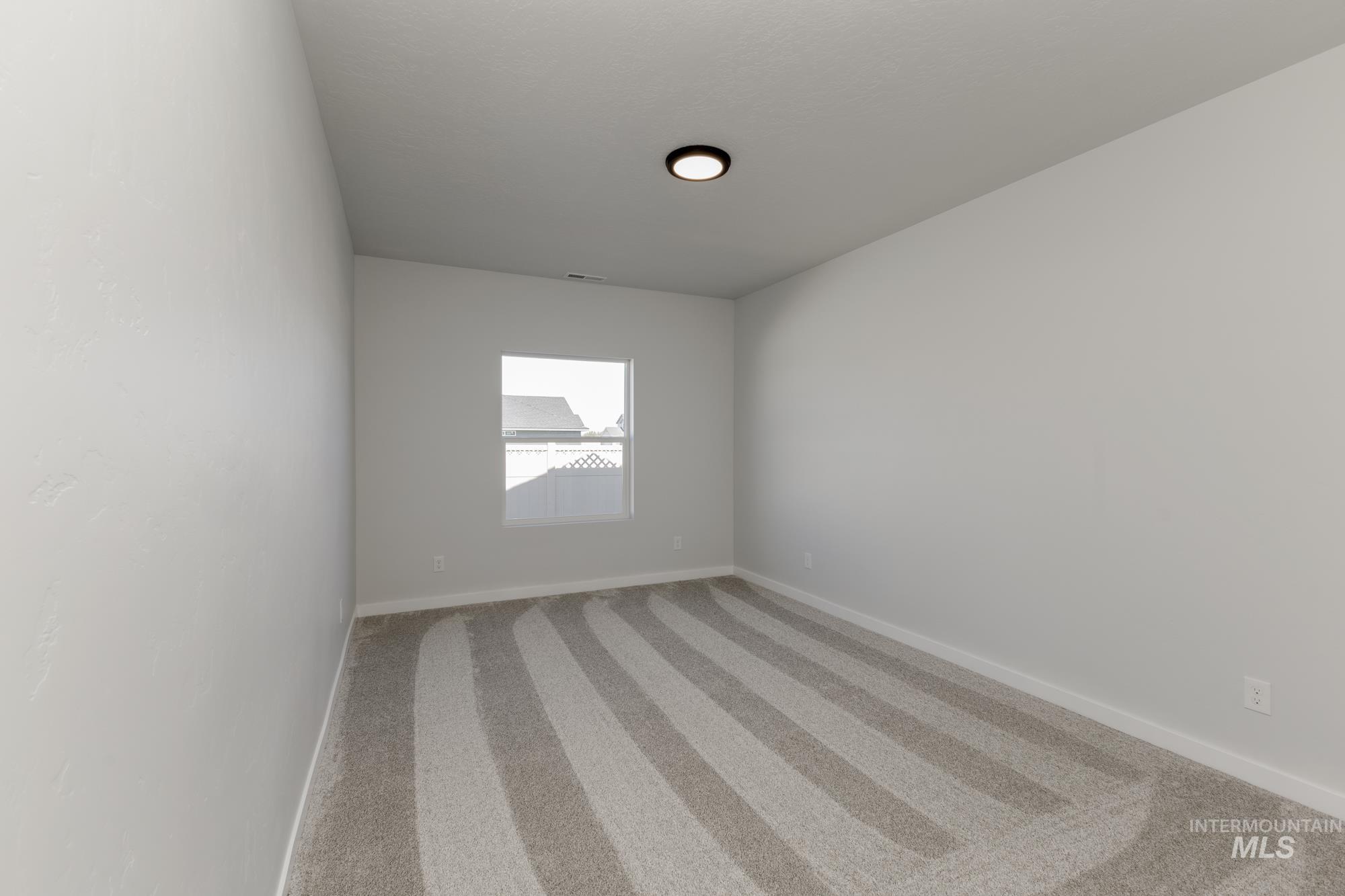 Unfurnished room with carpet floors and baseboards