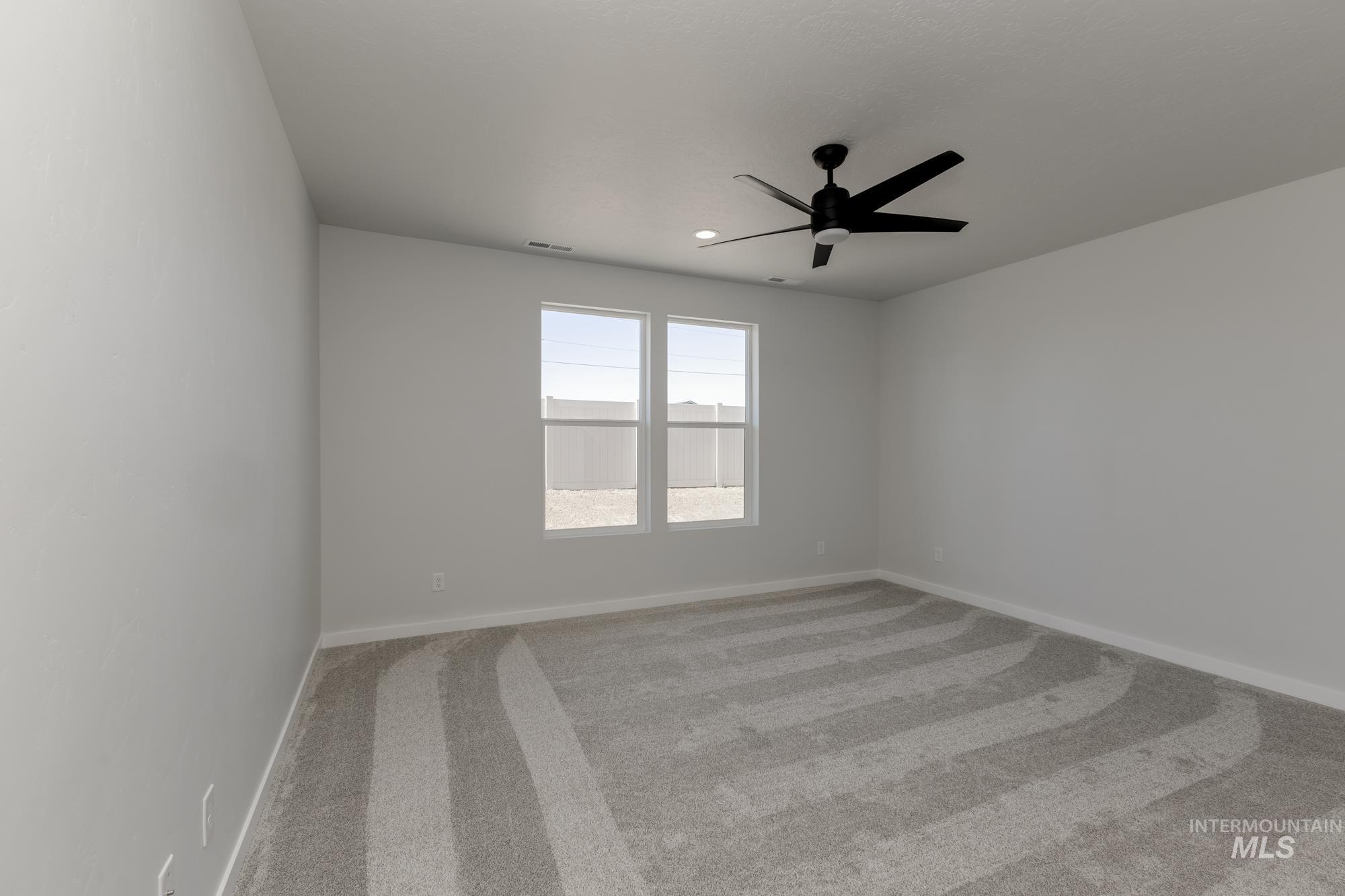 Empty room with carpet flooring, ceiling fan, and recessed lighting