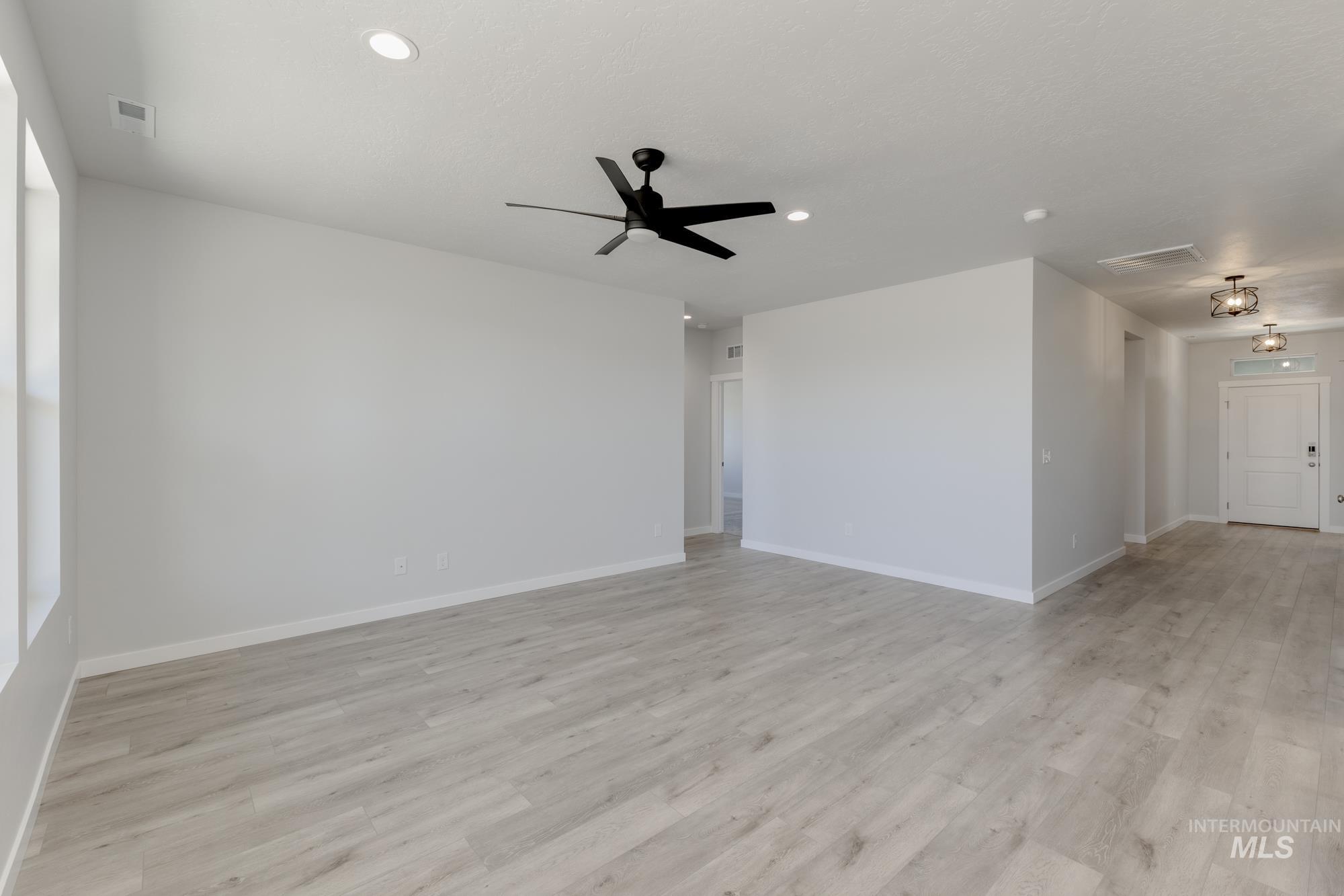 Spare room featuring light wood-type flooring, recessed lighting, and a ceiling fan