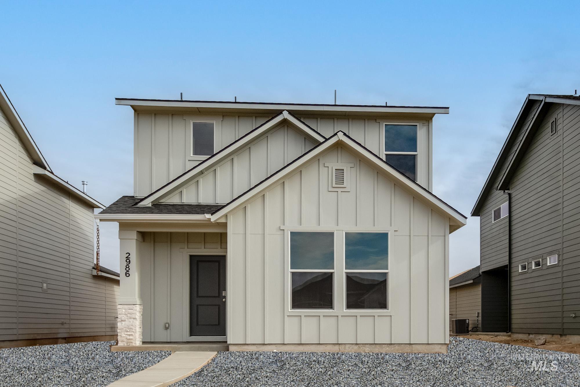 View of front of property featuring board and batten siding and roof with shingles