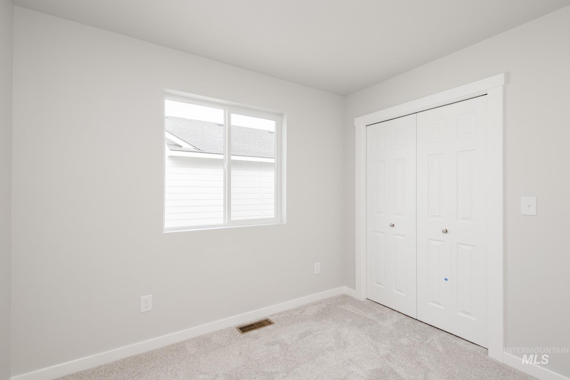 Unfurnished bedroom with carpet and a closet