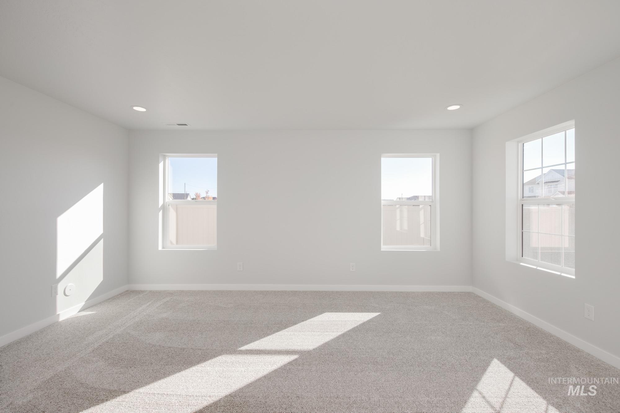 Empty room featuring carpet and recessed lighting
