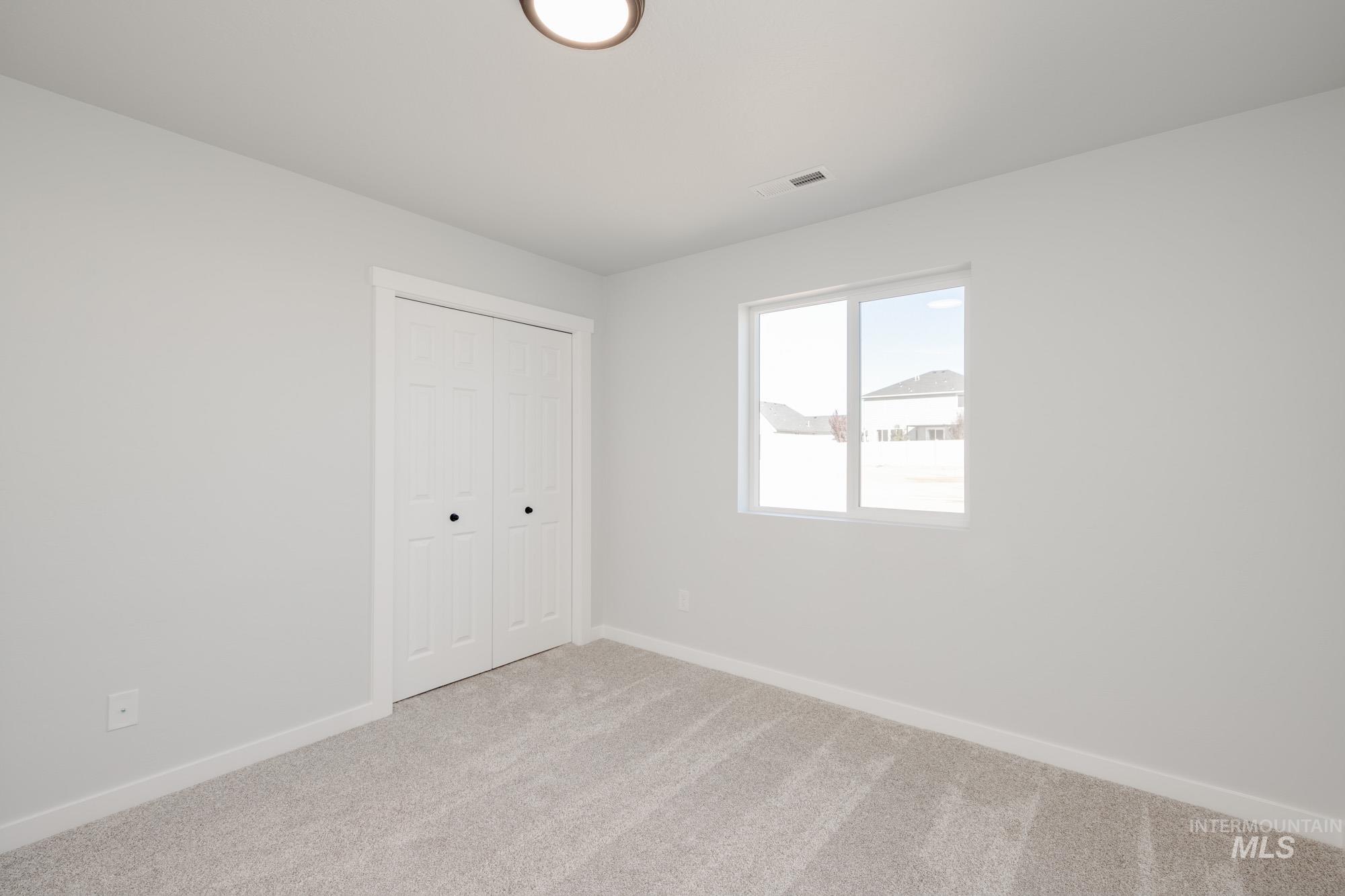 Unfurnished bedroom with carpet flooring and a closet