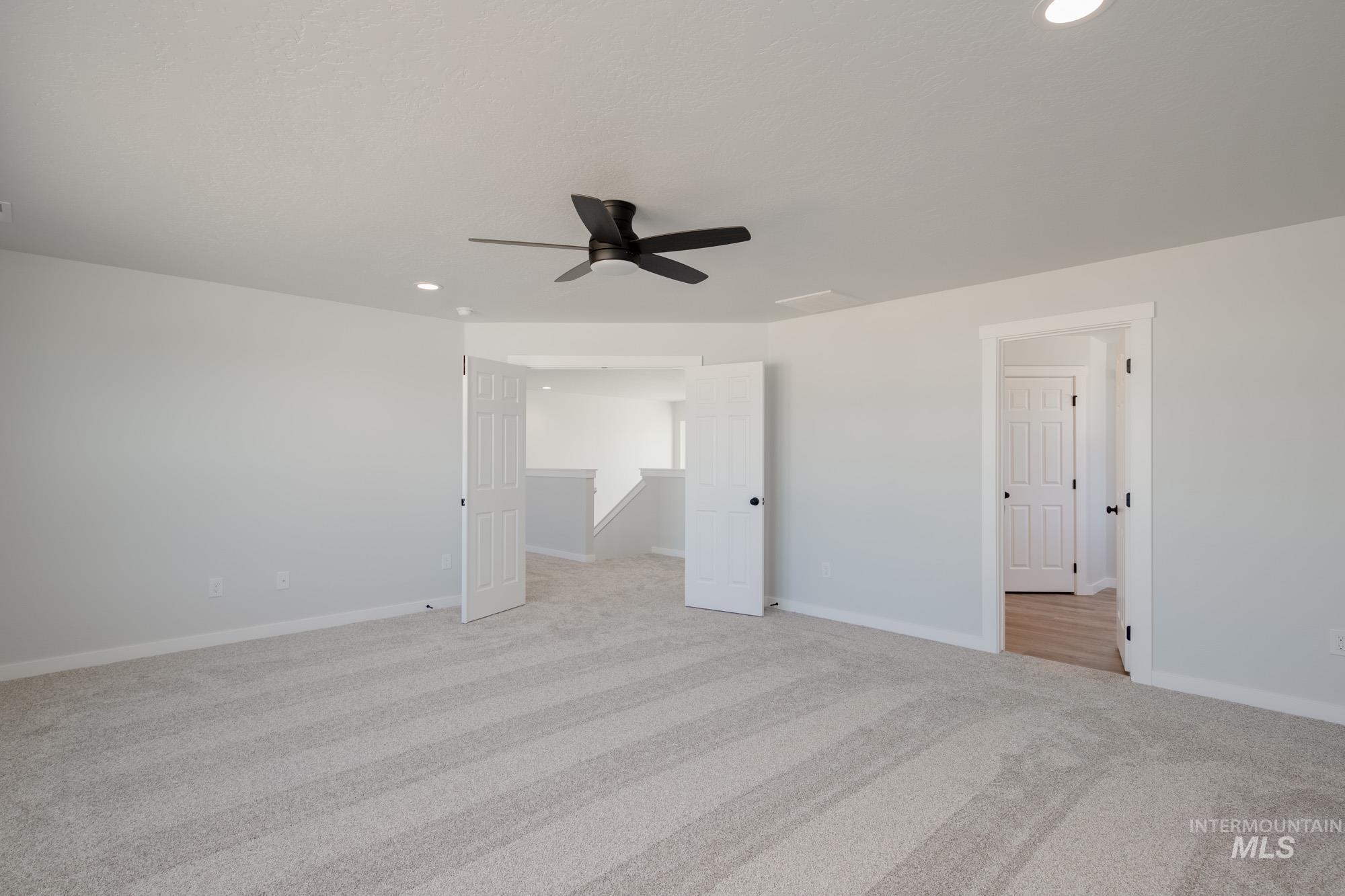 Unfurnished bedroom with a ceiling fan, light colored carpet, and recessed lighting