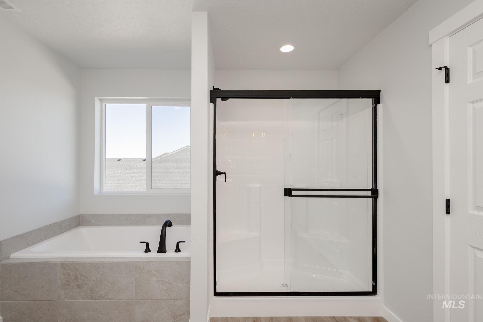 Full bath featuring a garden tub, a stall shower, and recessed lighting