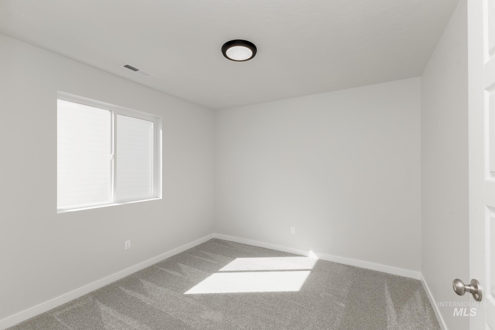 Unfurnished room with carpet and baseboards