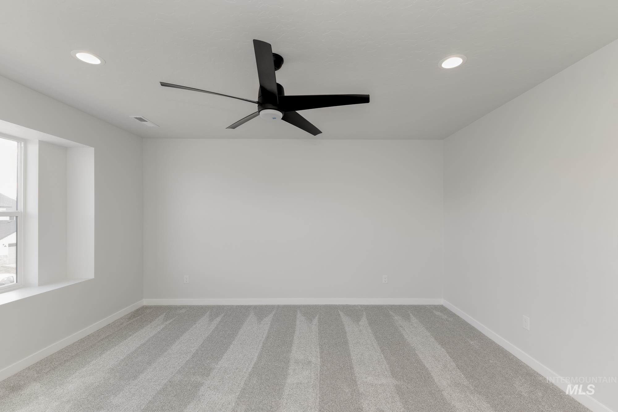 Empty room with carpet, recessed lighting, and ceiling fan