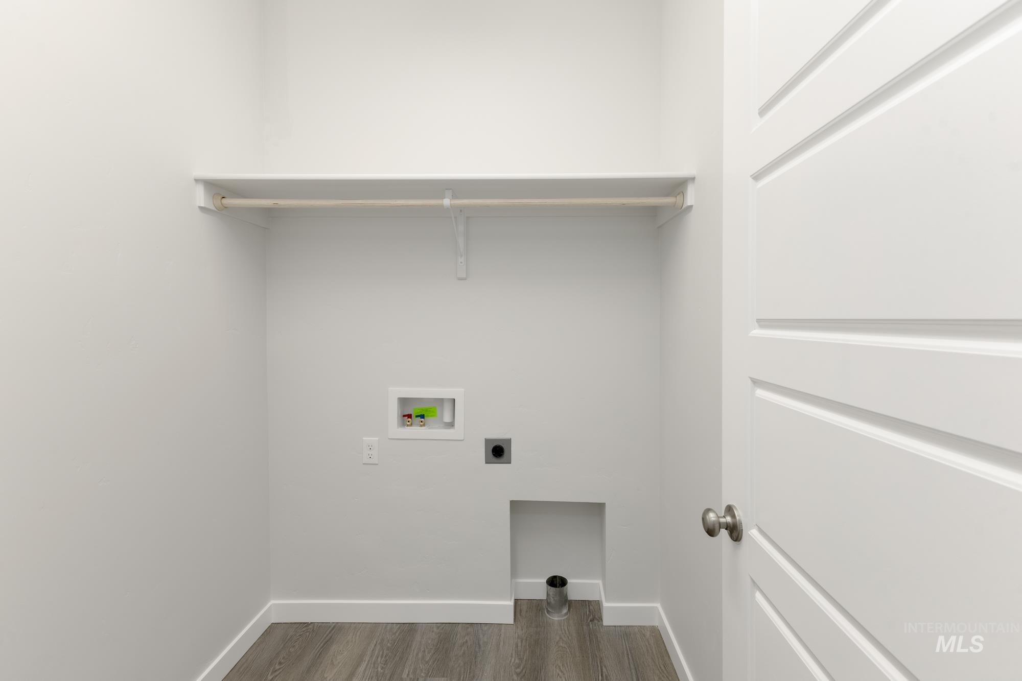 Washroom with dark wood-style floors, hookup for a washing machine, and electric dryer hookup