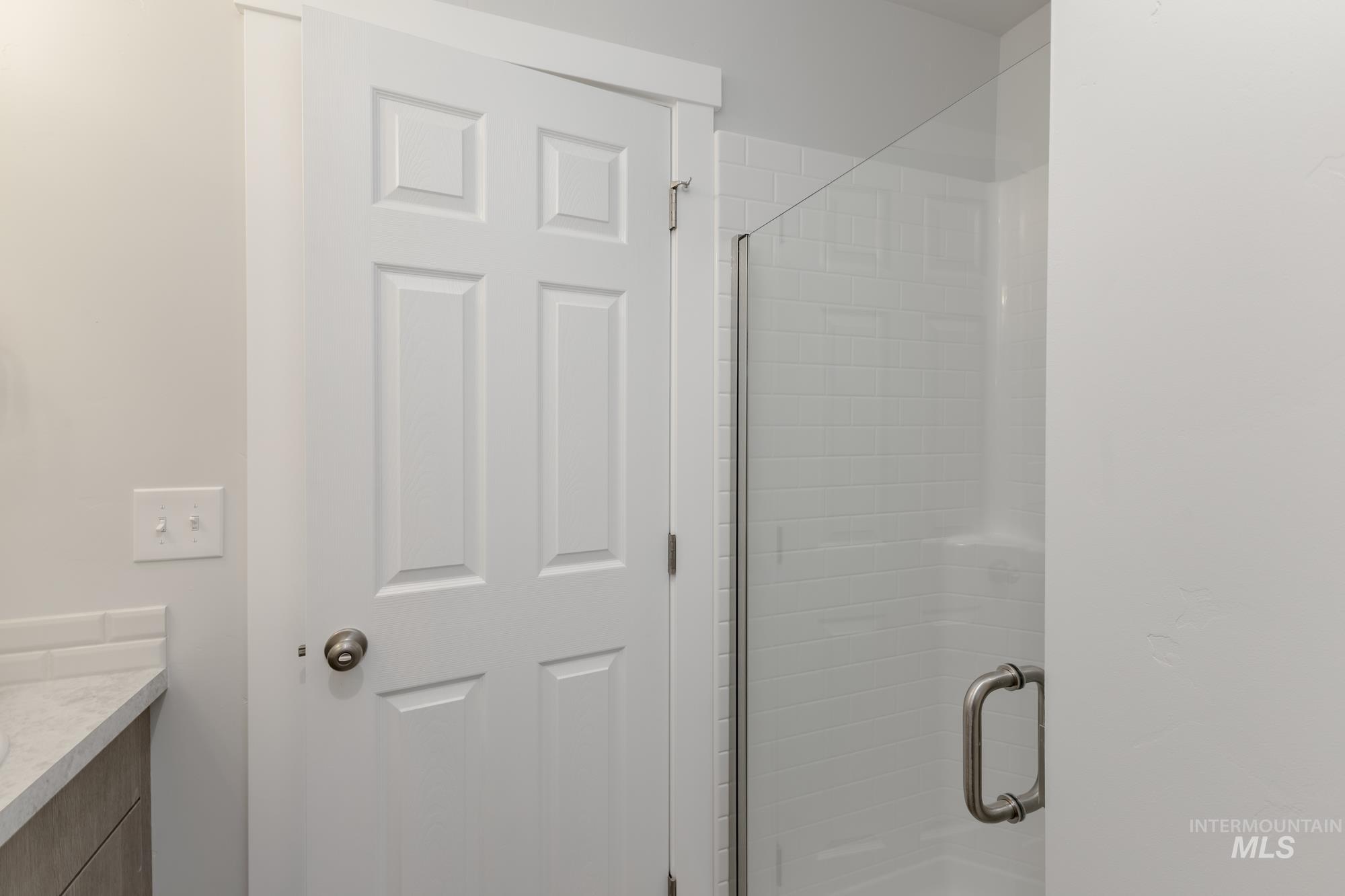 Full bathroom featuring vanity and a shower stall