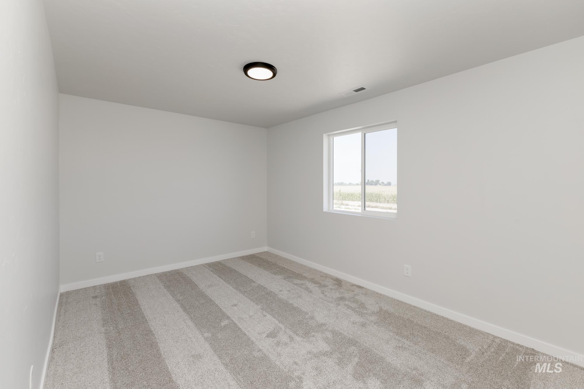 Unfurnished room featuring carpet floors and baseboards
