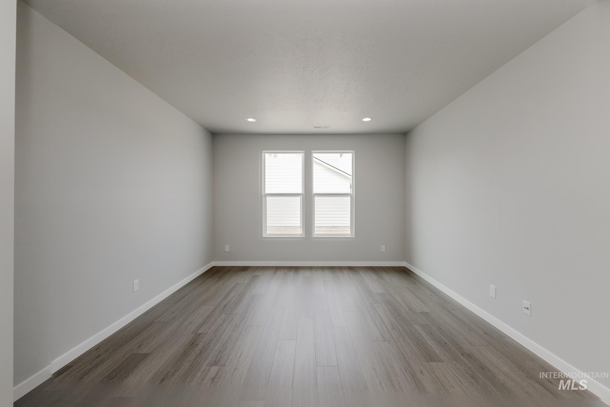 Unfurnished room with light wood-style floors and recessed lighting