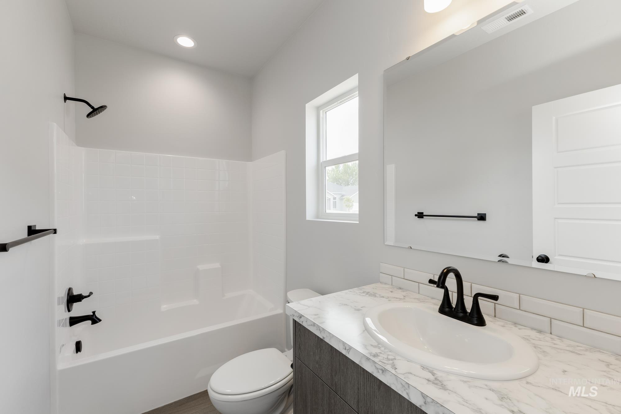 Bathroom with shower / bathtub combination and vanity
