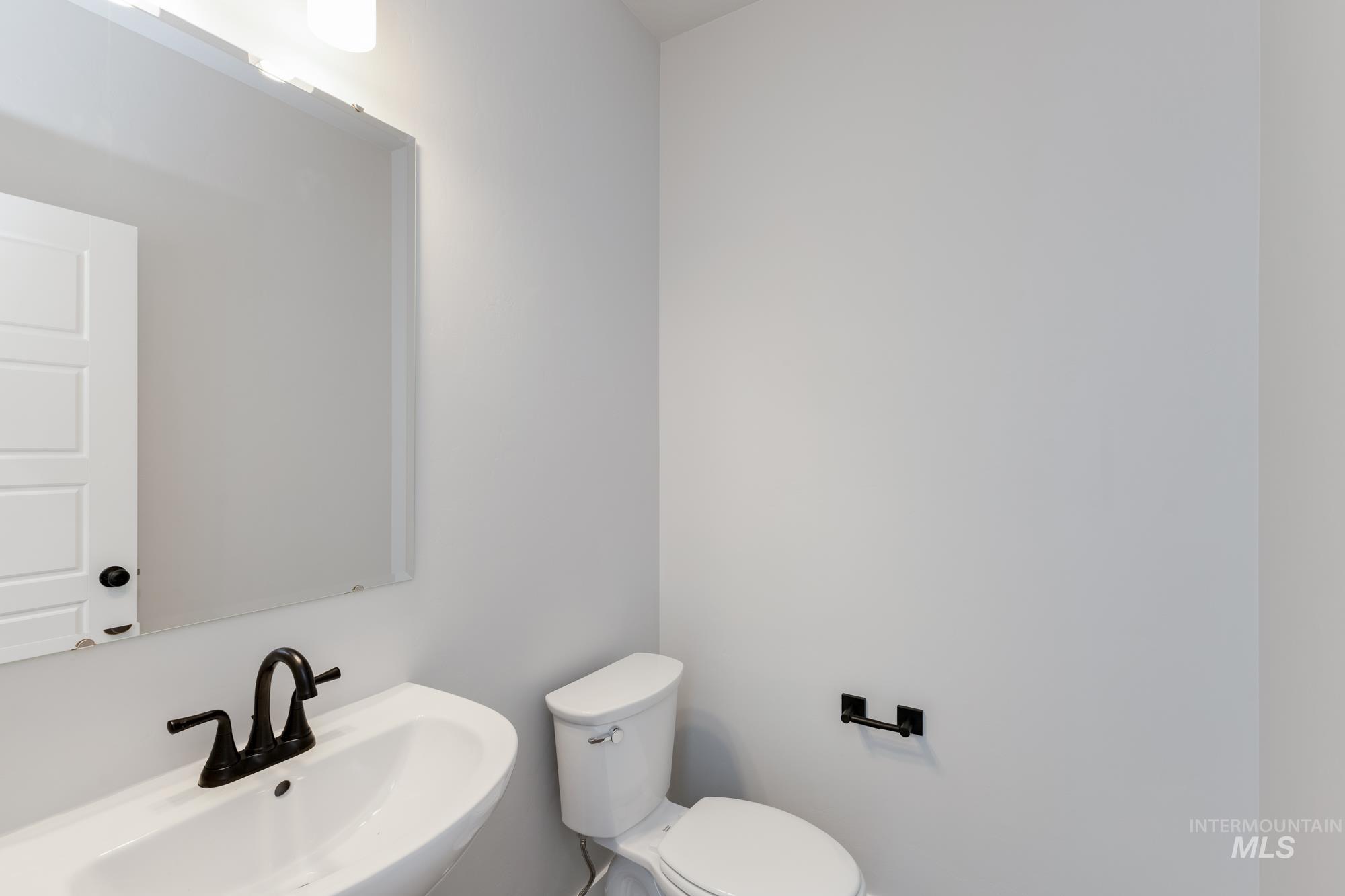 Half bath featuring toilet and a sink