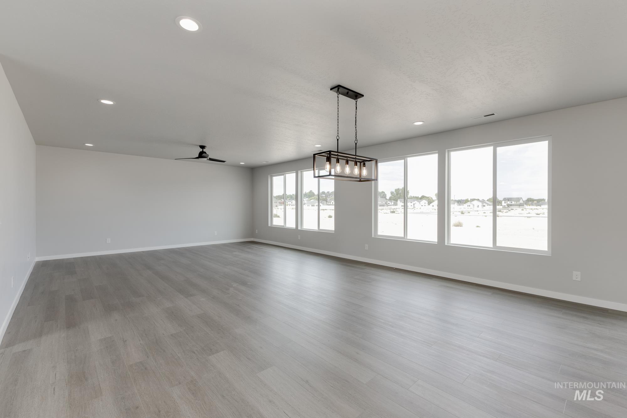Unfurnished living room with a ceiling fan, light wood-style floors, and recessed lighting