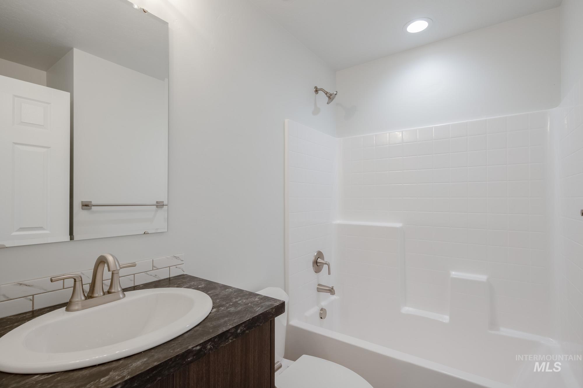 Bathroom with shower / bathtub combination and vanity