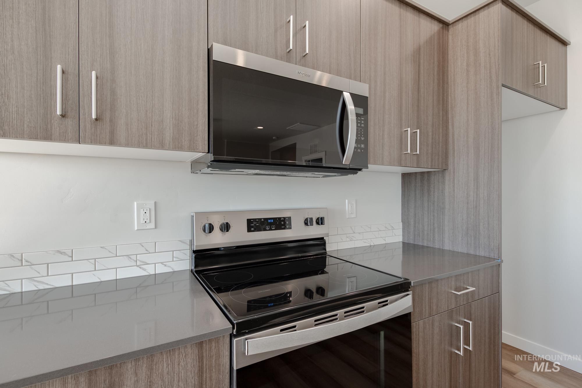 Kitchen featuring modern cabinets and appliances with stainless steel finishes