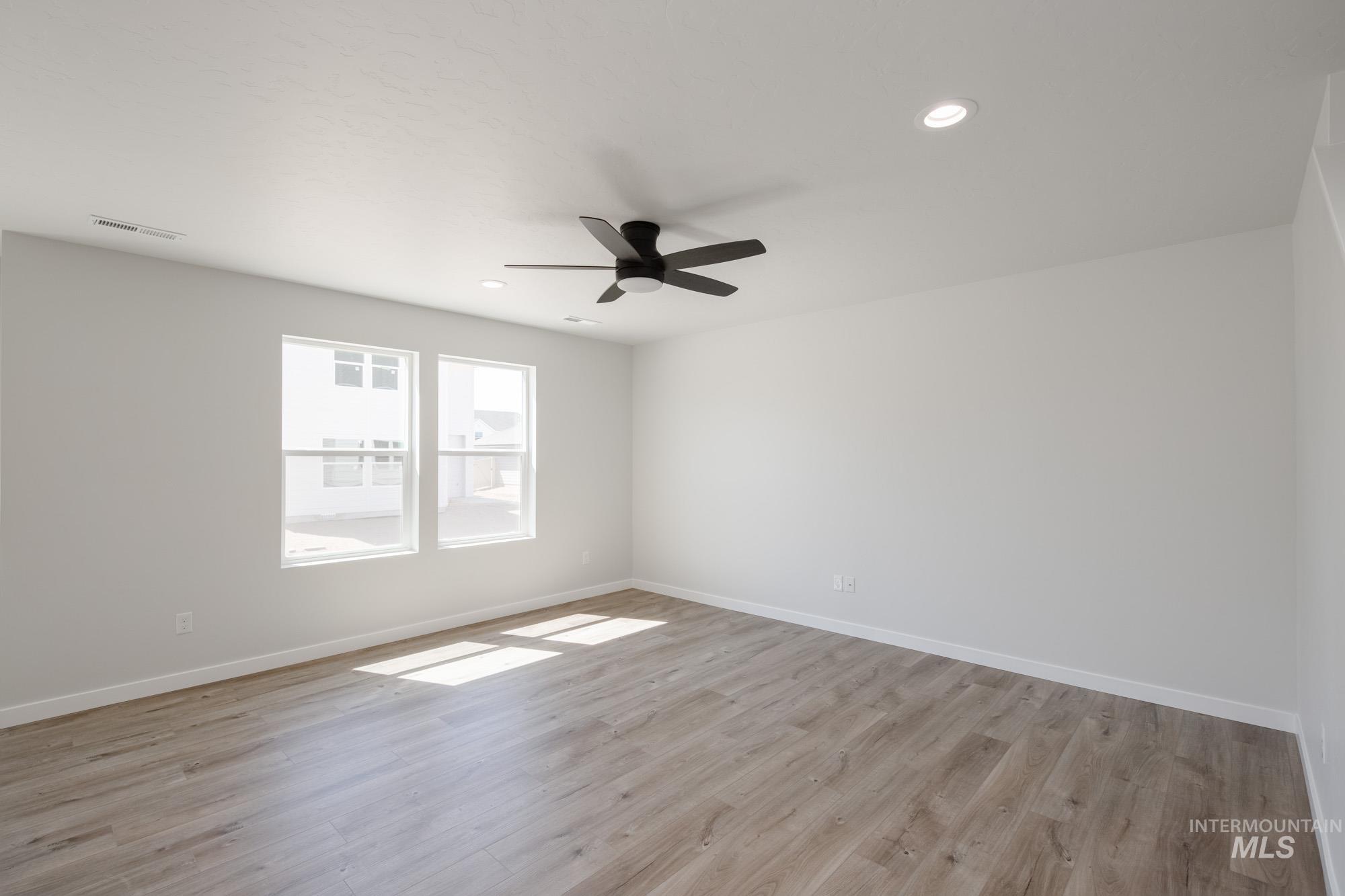 Unfurnished room with light wood-style flooring, recessed lighting, and a ceiling fan