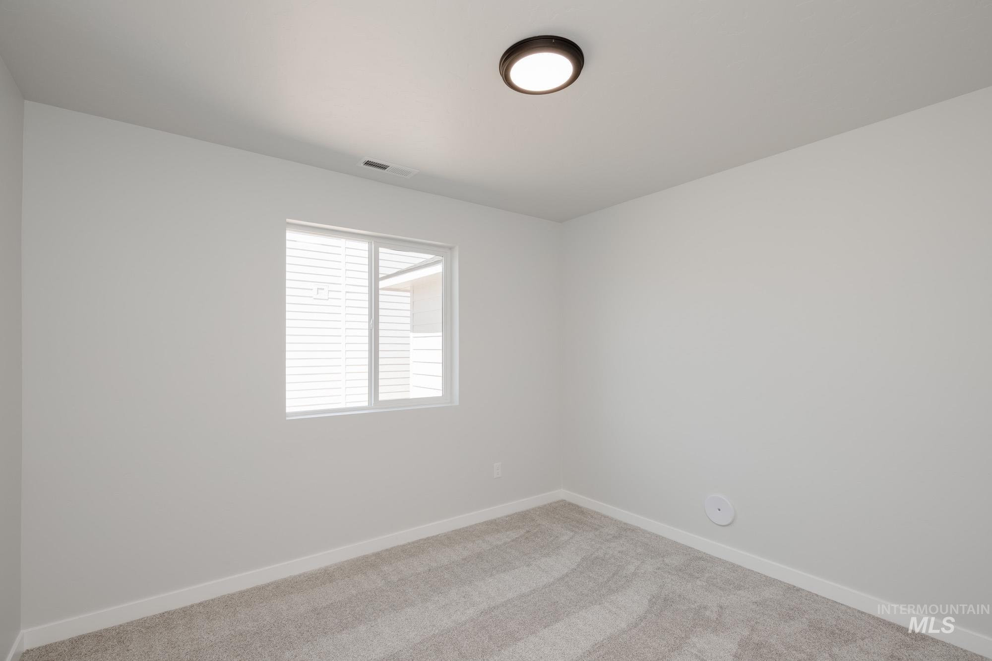 Unfurnished room featuring carpet flooring and baseboards