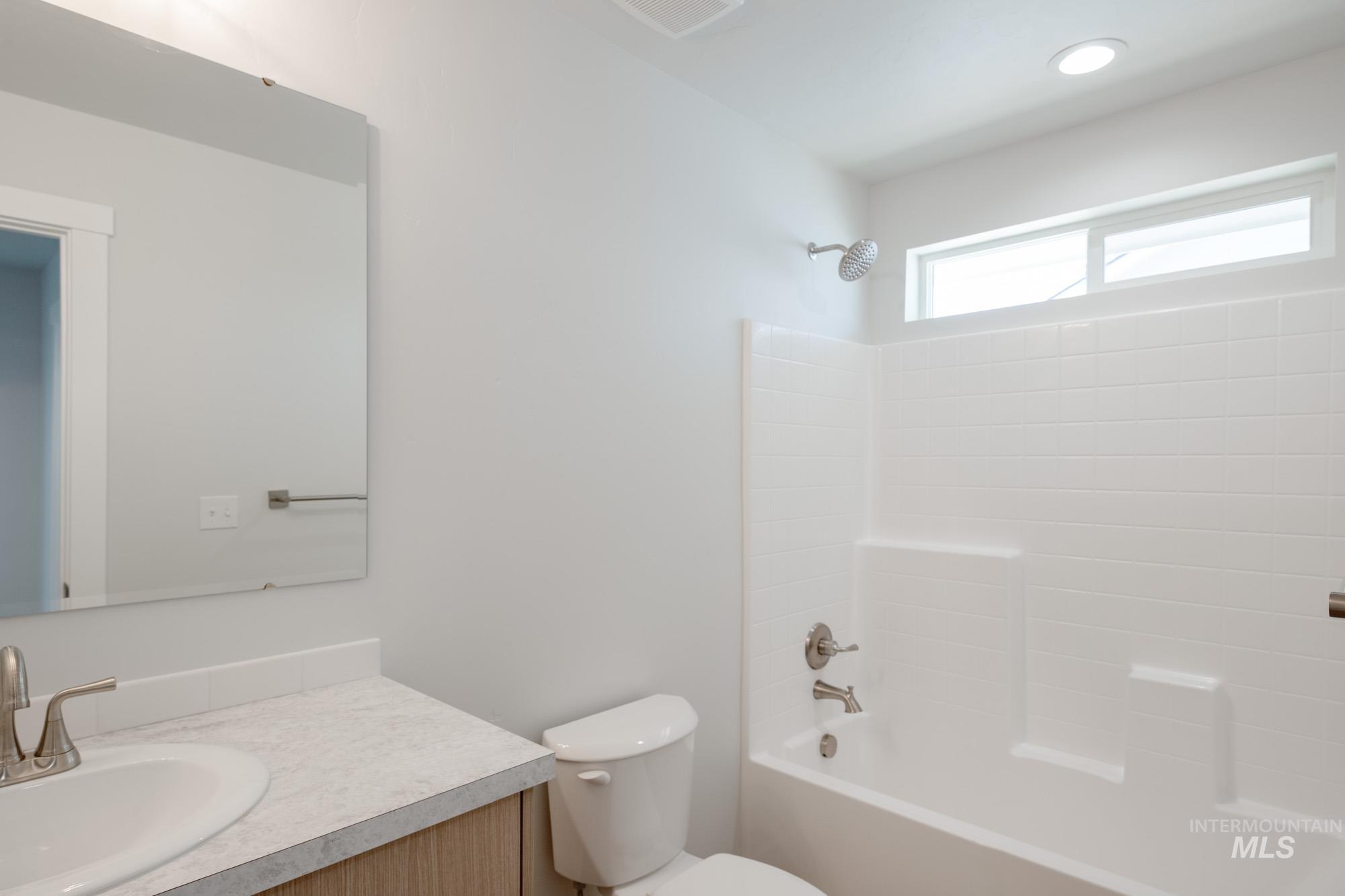 Full bath featuring vanity and bathtub / shower combination
