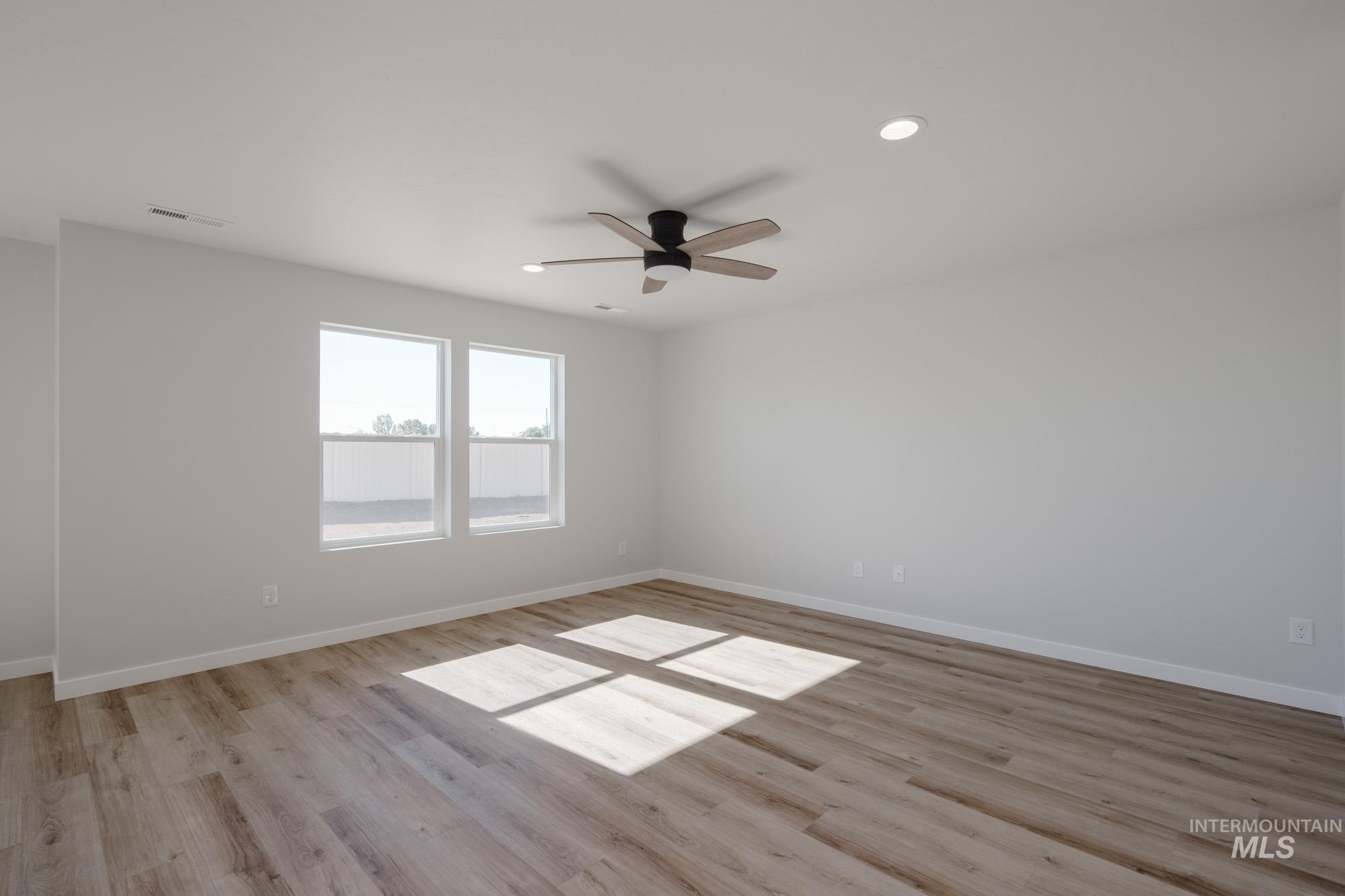 Empty room featuring recessed lighting, light wood finished floors, and ceiling fan
