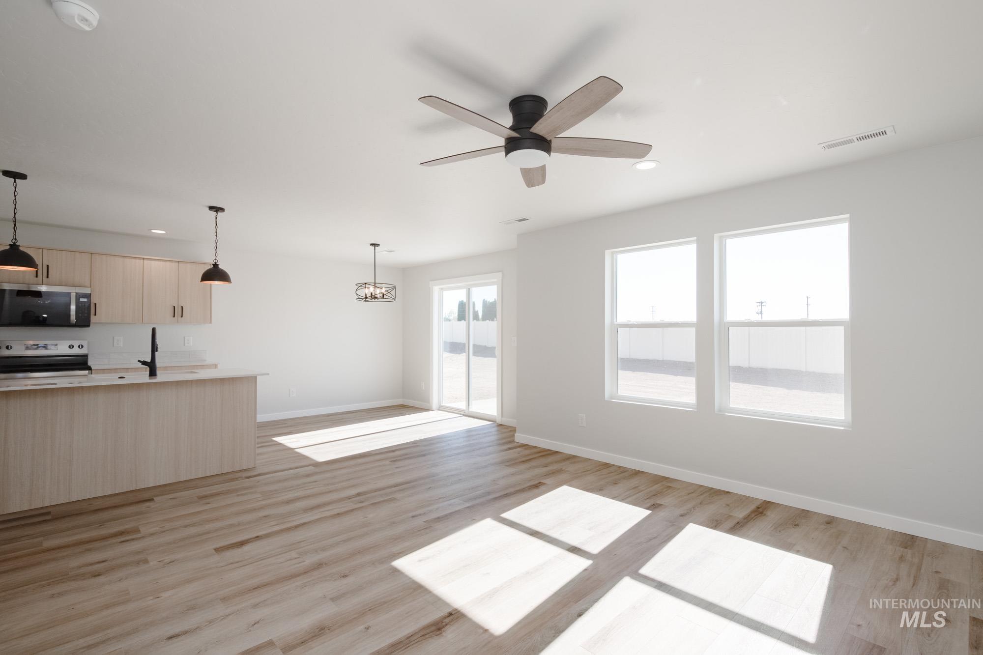 Unfurnished living room with light wood-style flooring, recessed lighting, and ceiling fan
