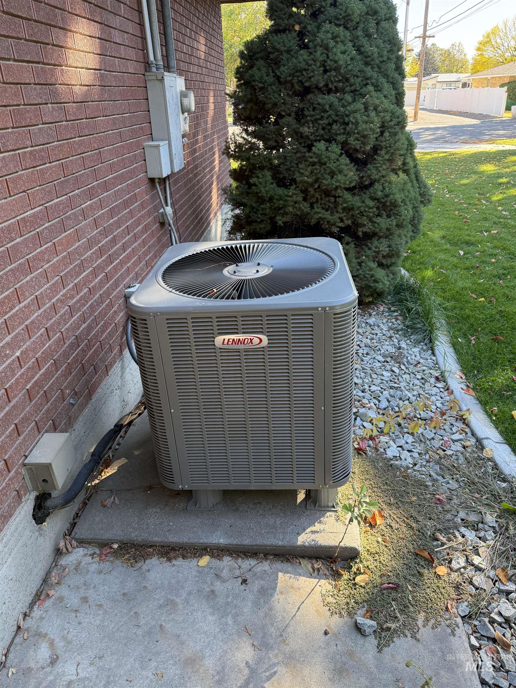 Exterior view of brick siding and a central AC unit