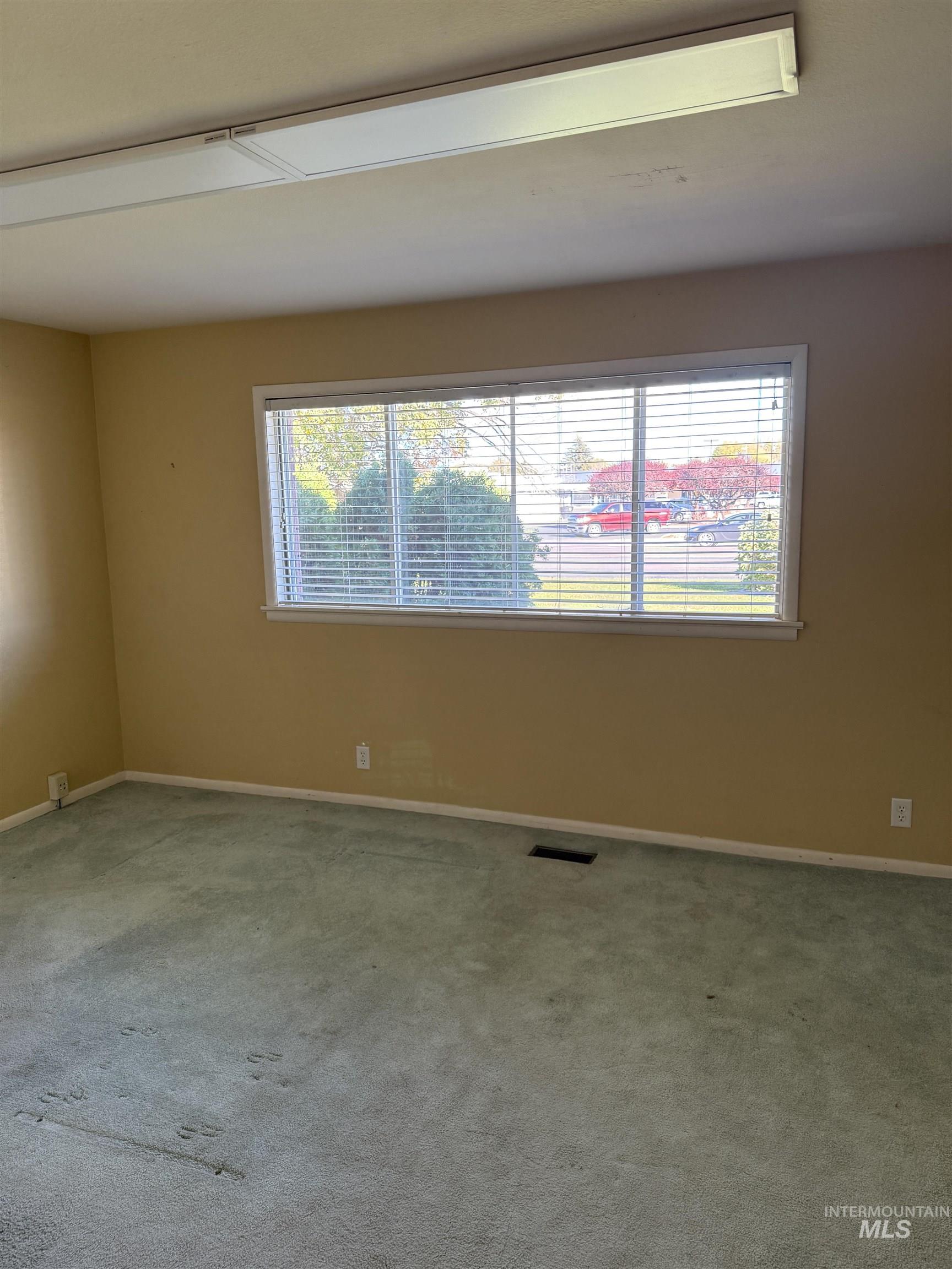 Carpeted spare room with plenty of natural light