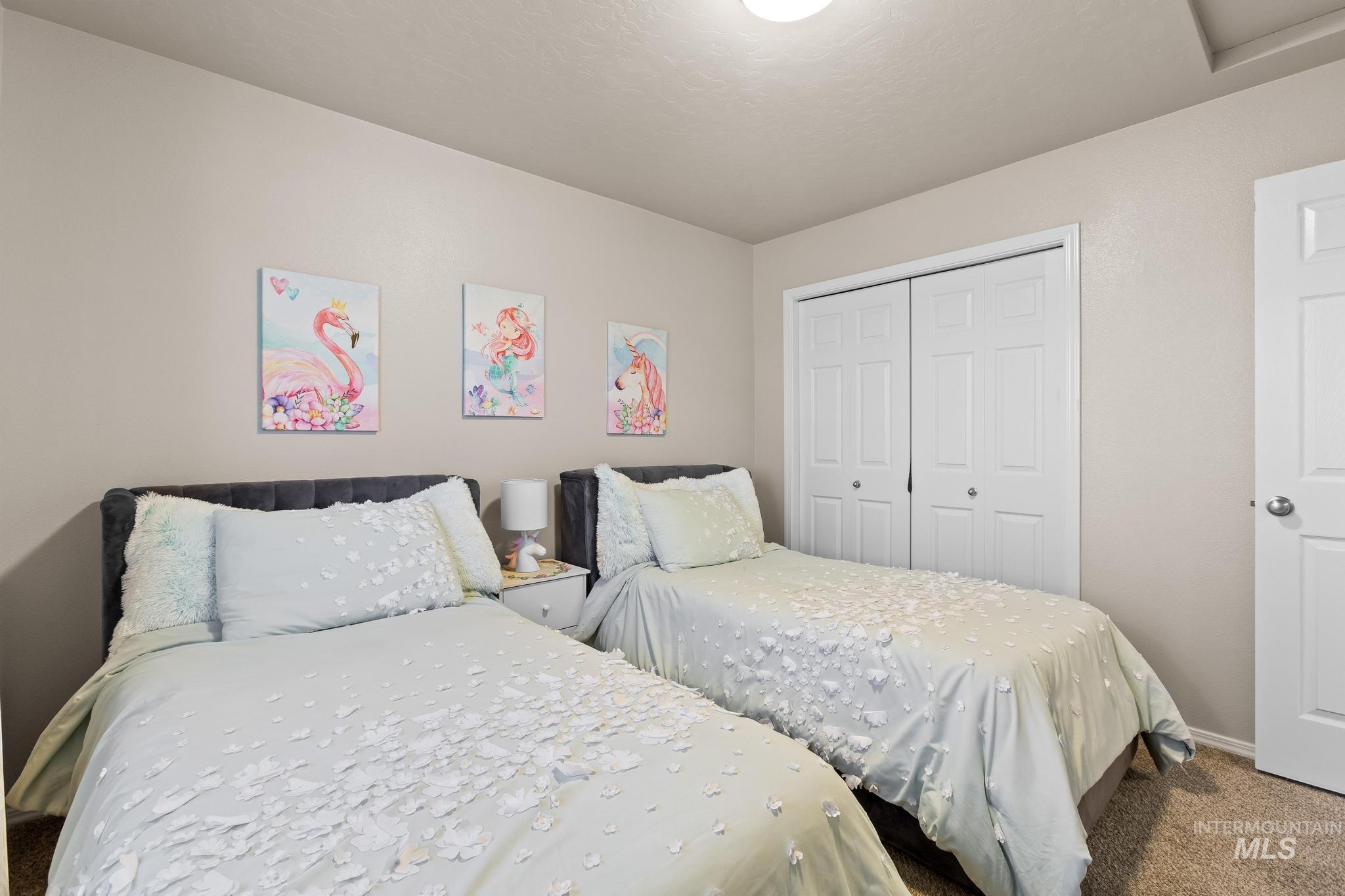 Carpeted bedroom with a closet and baseboards