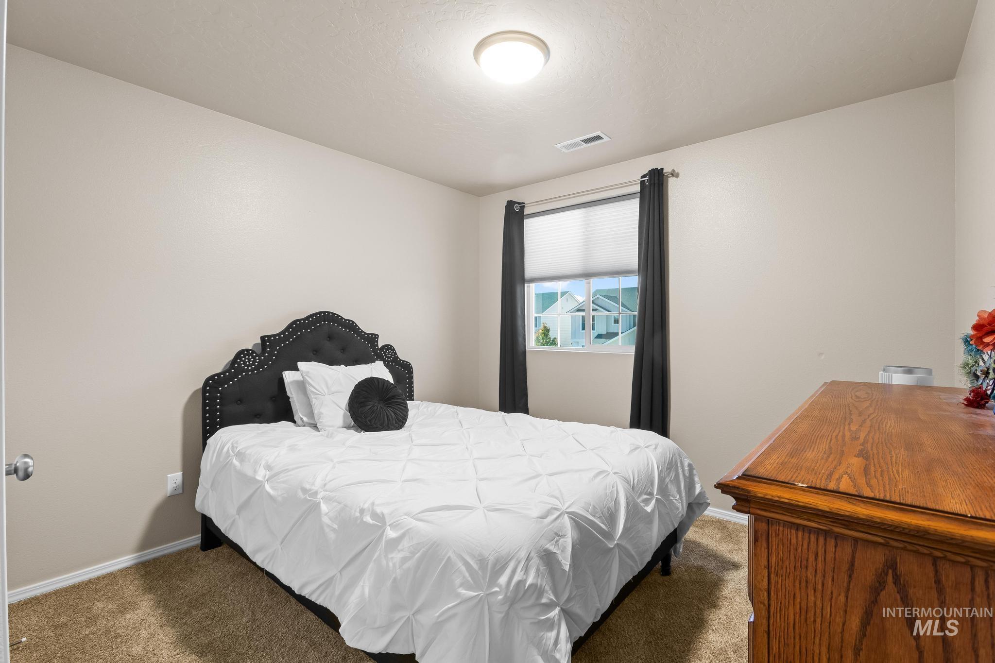 Bedroom with carpet and baseboards