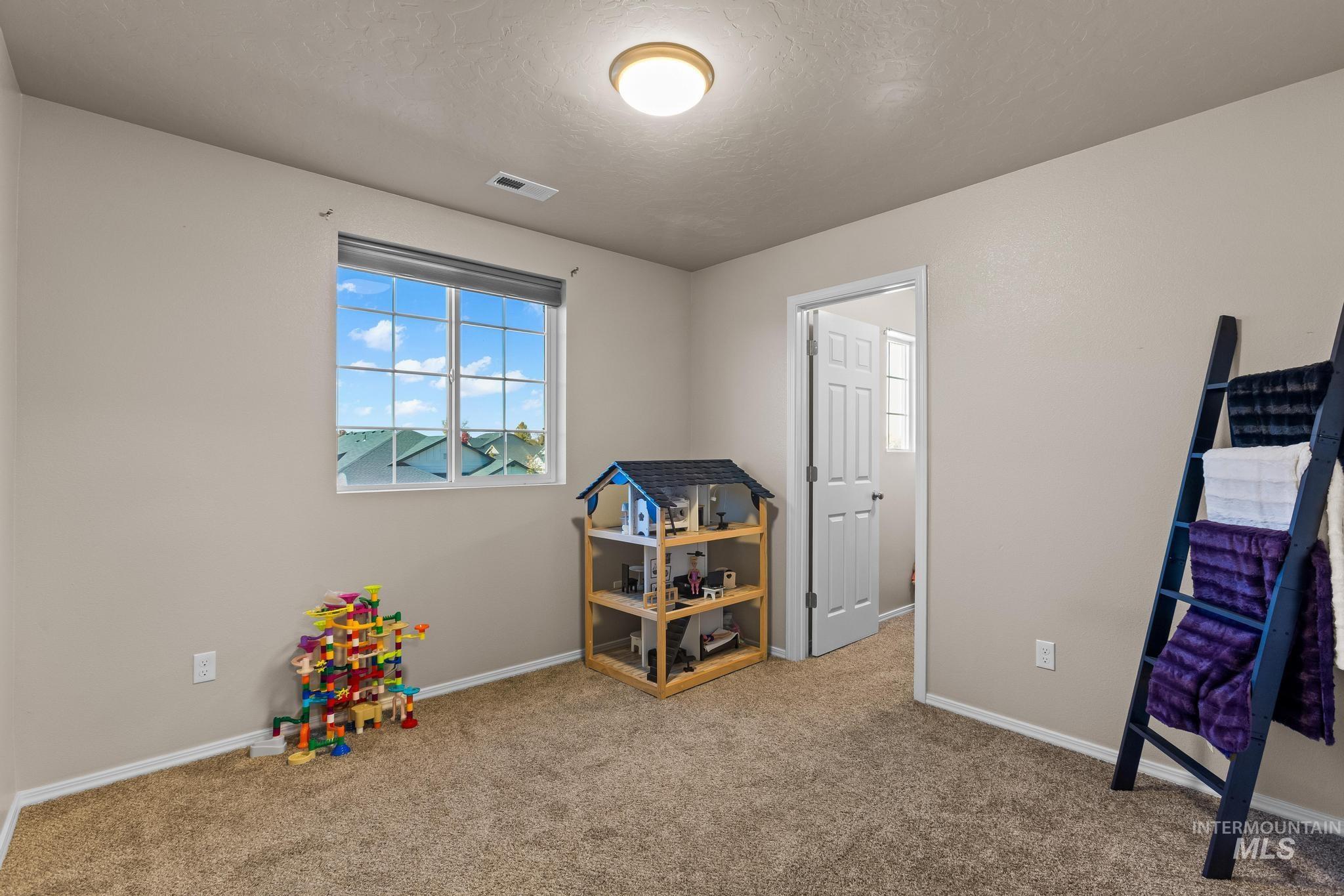 Bedroom with carpet flooring and a textured ceiling