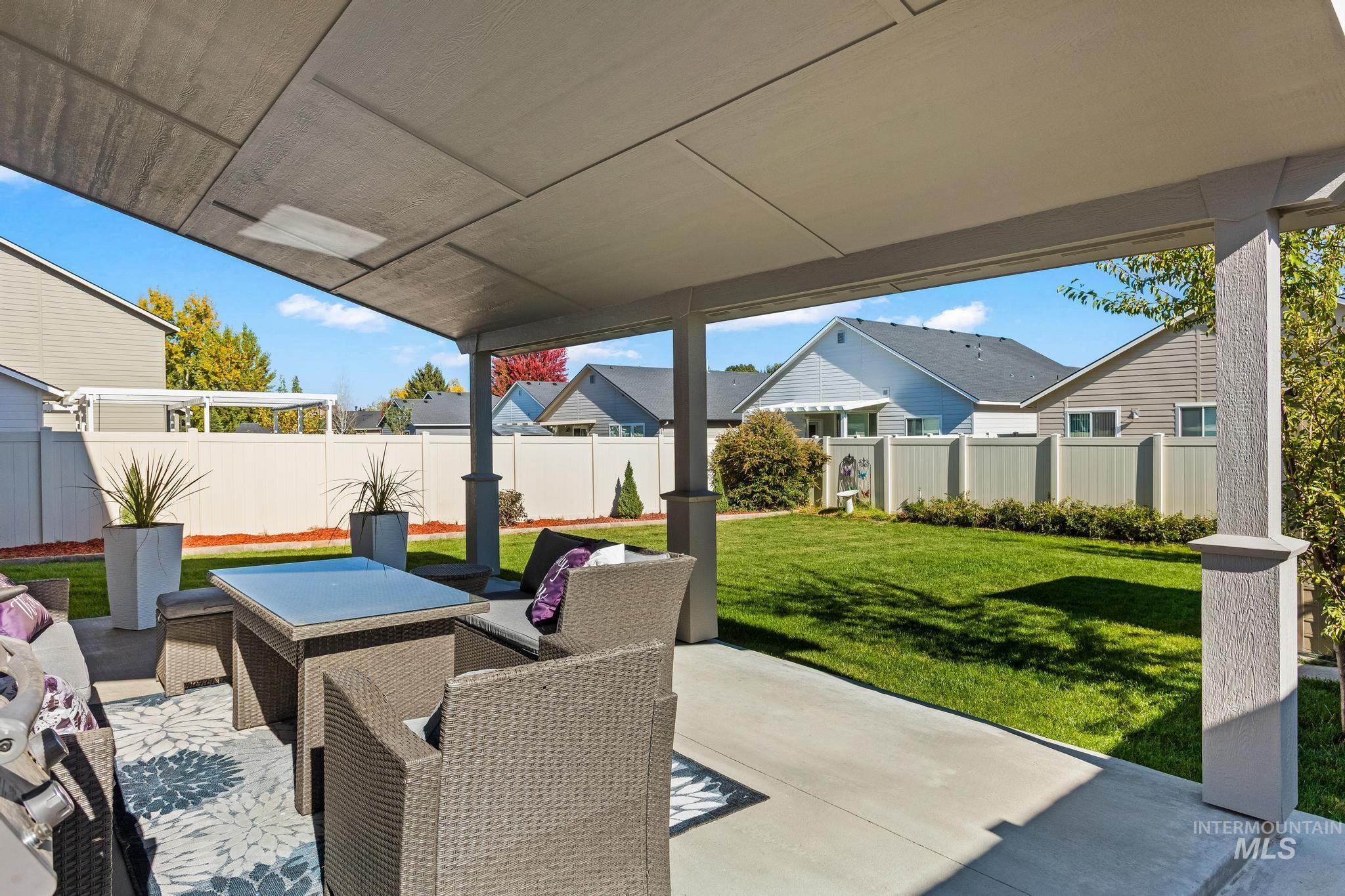 Fenced backyard with a patio area and a residential view