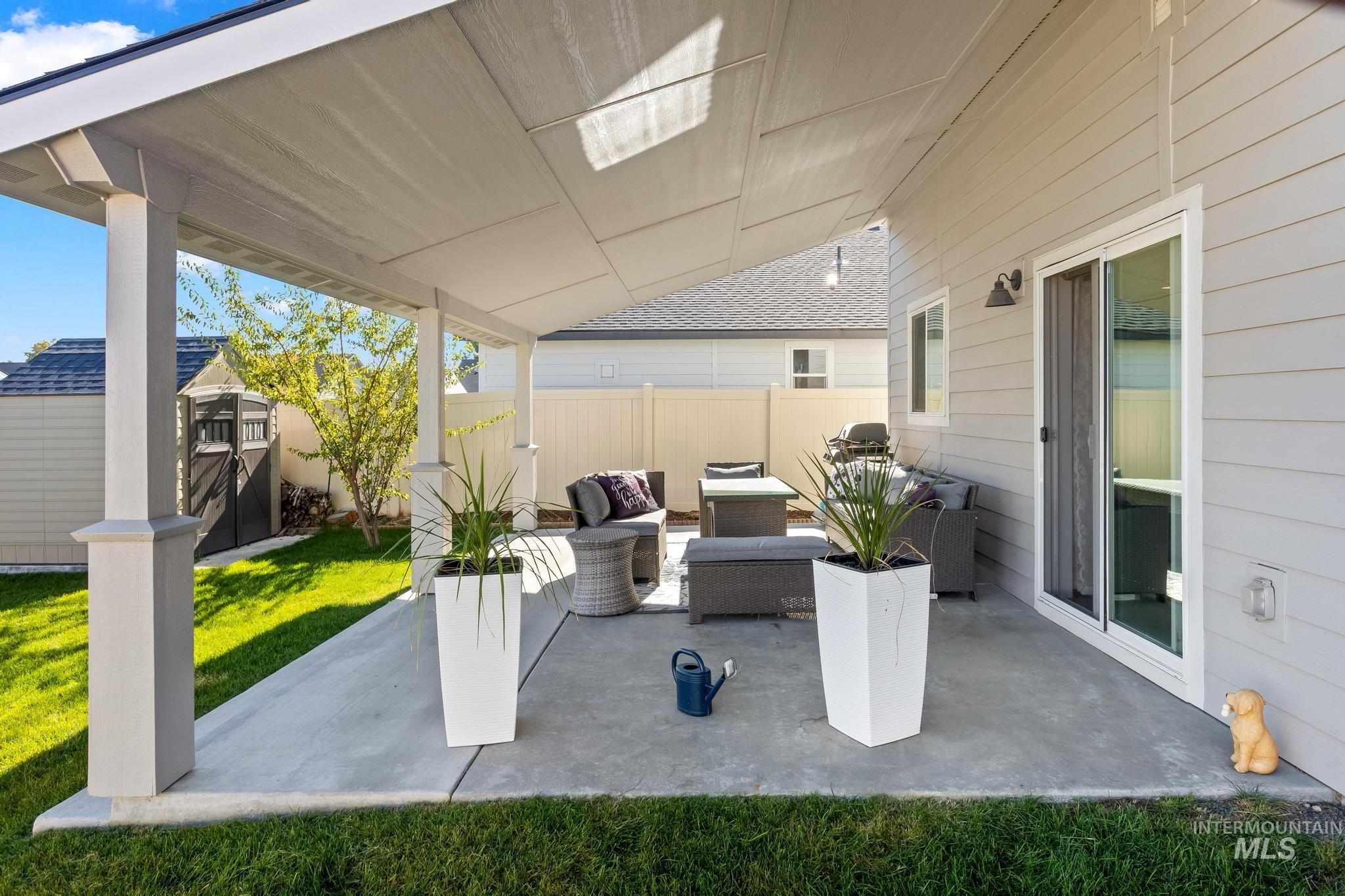 View of patio with a storage unit and an outdoor hangout area