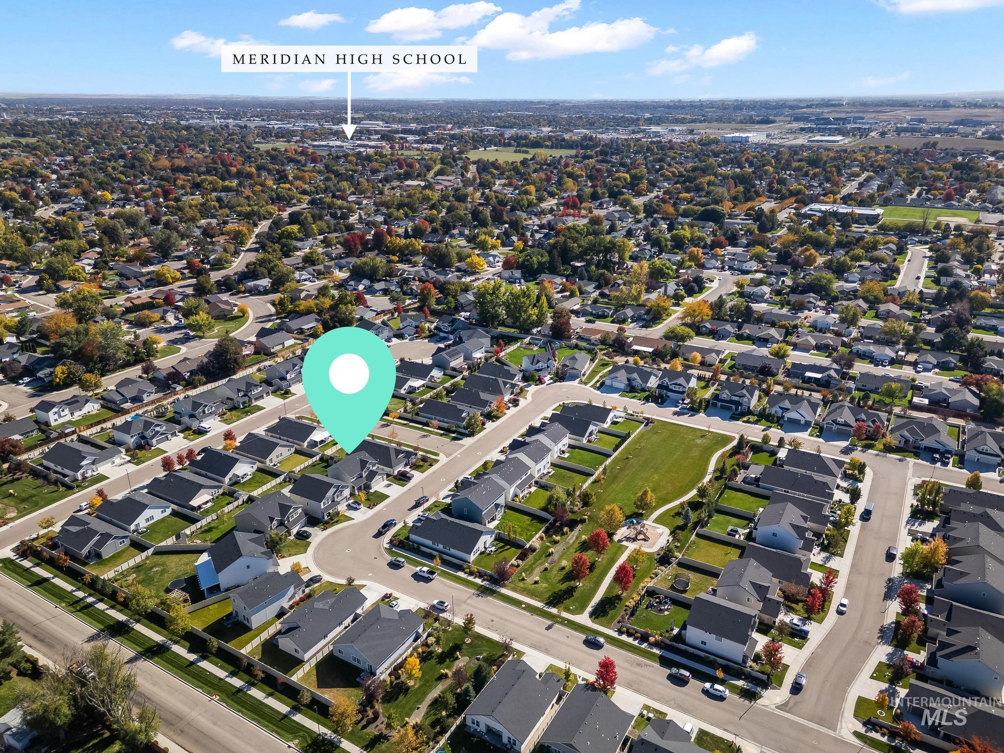 Aerial view of property's location with nearby suburban area