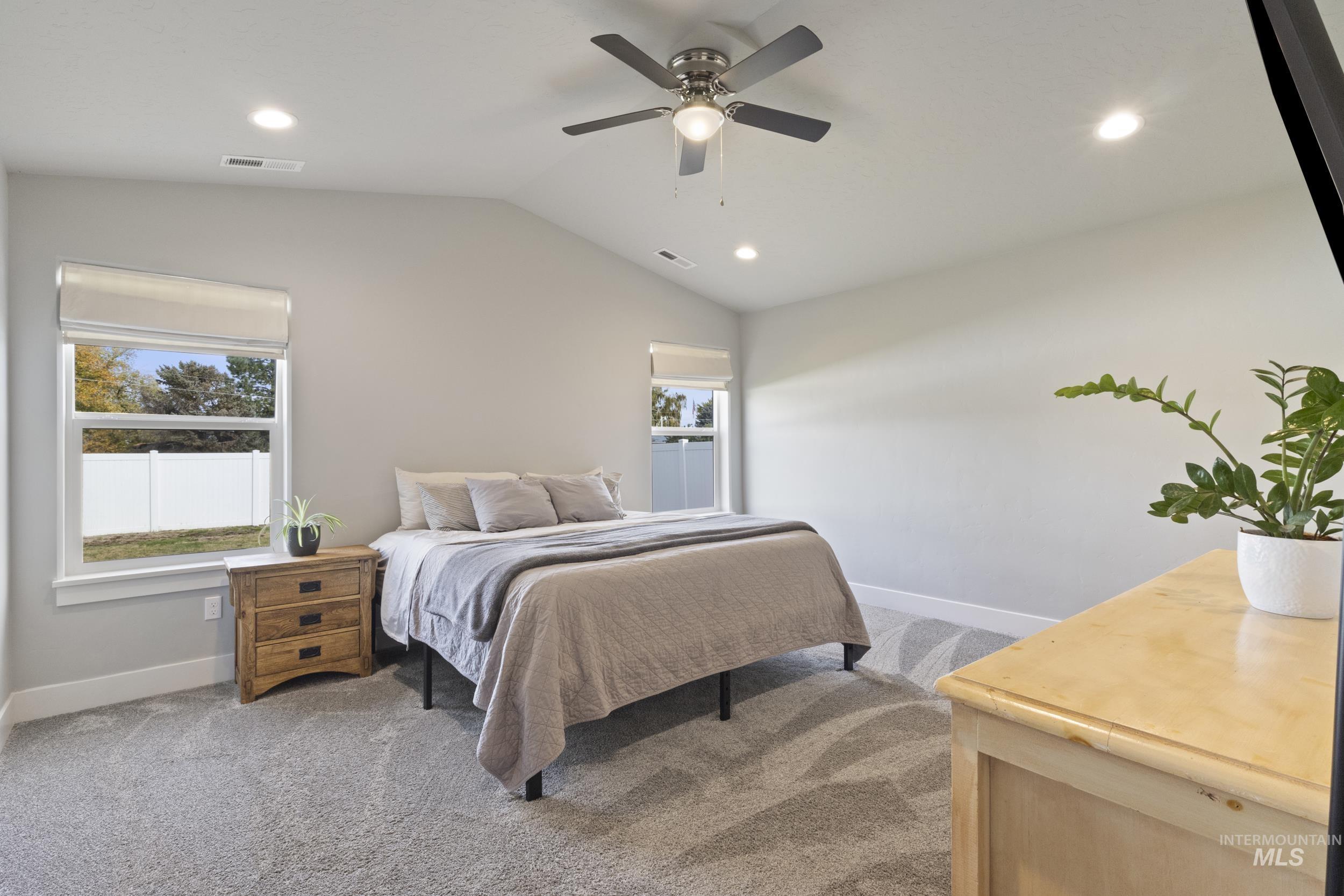 Bedroom with light carpet, lofted ceiling, recessed lighting, and a ceiling fan