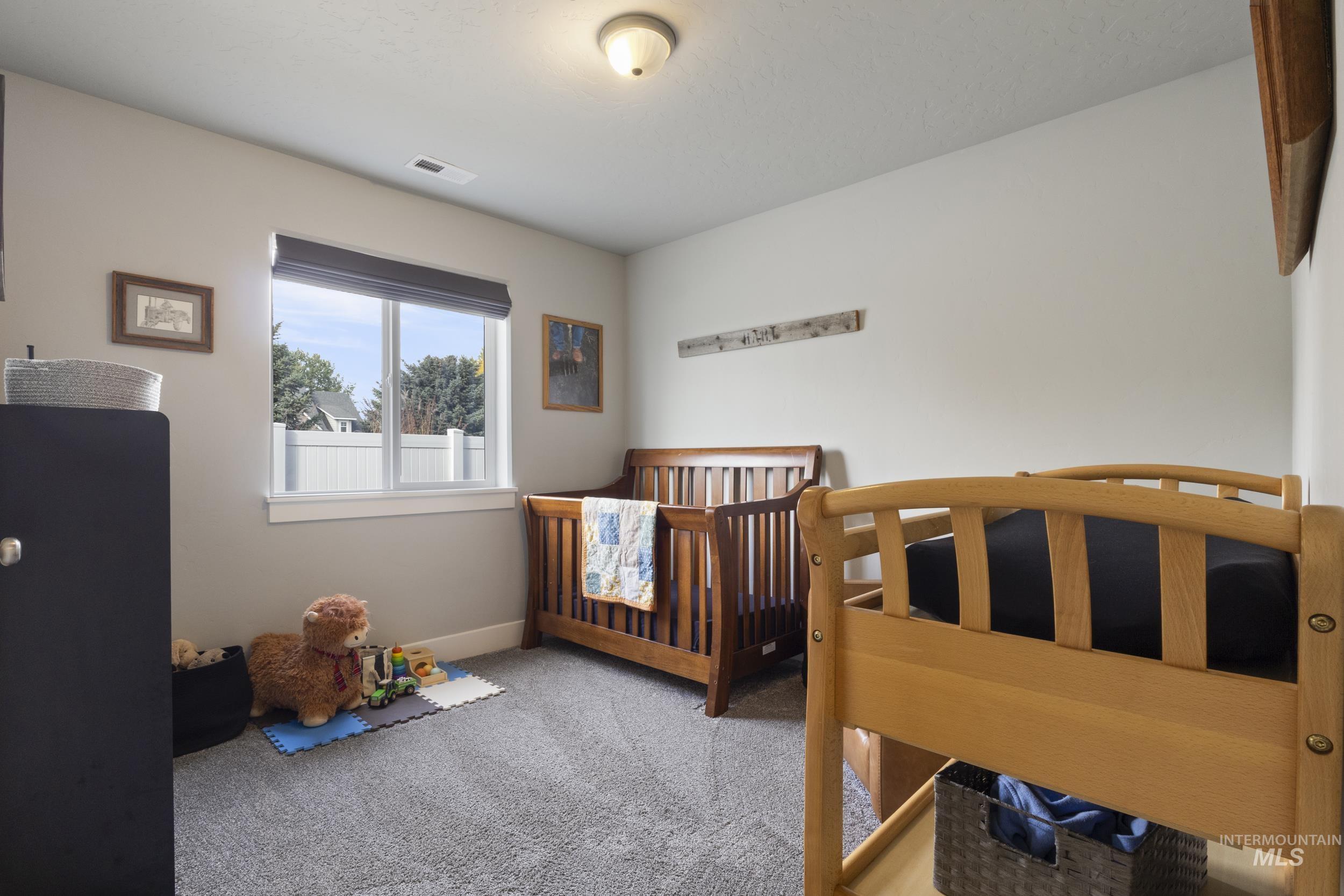 Bedroom with light carpet and baseboards