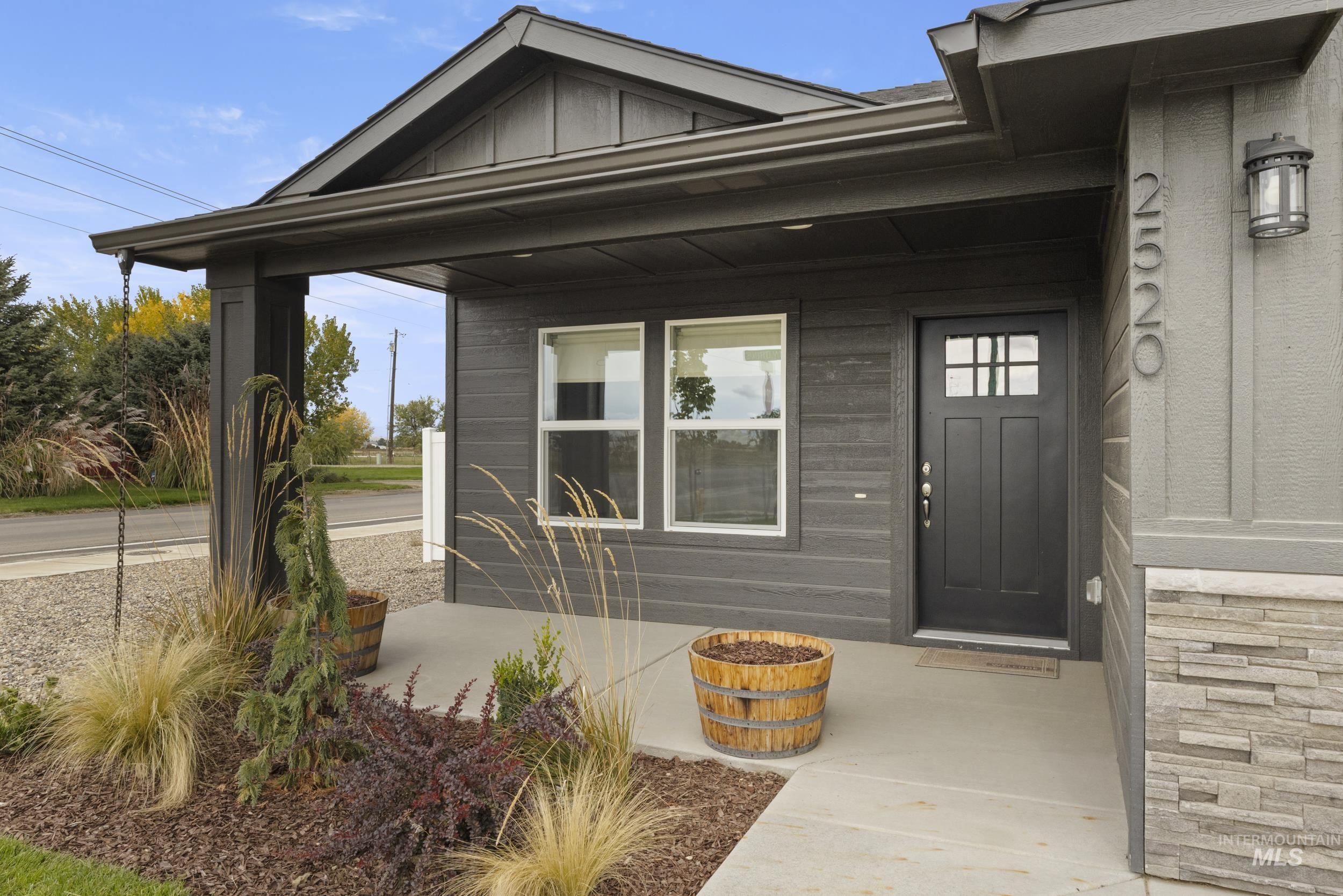 Doorway to property featuring covered porch and board and batten siding
