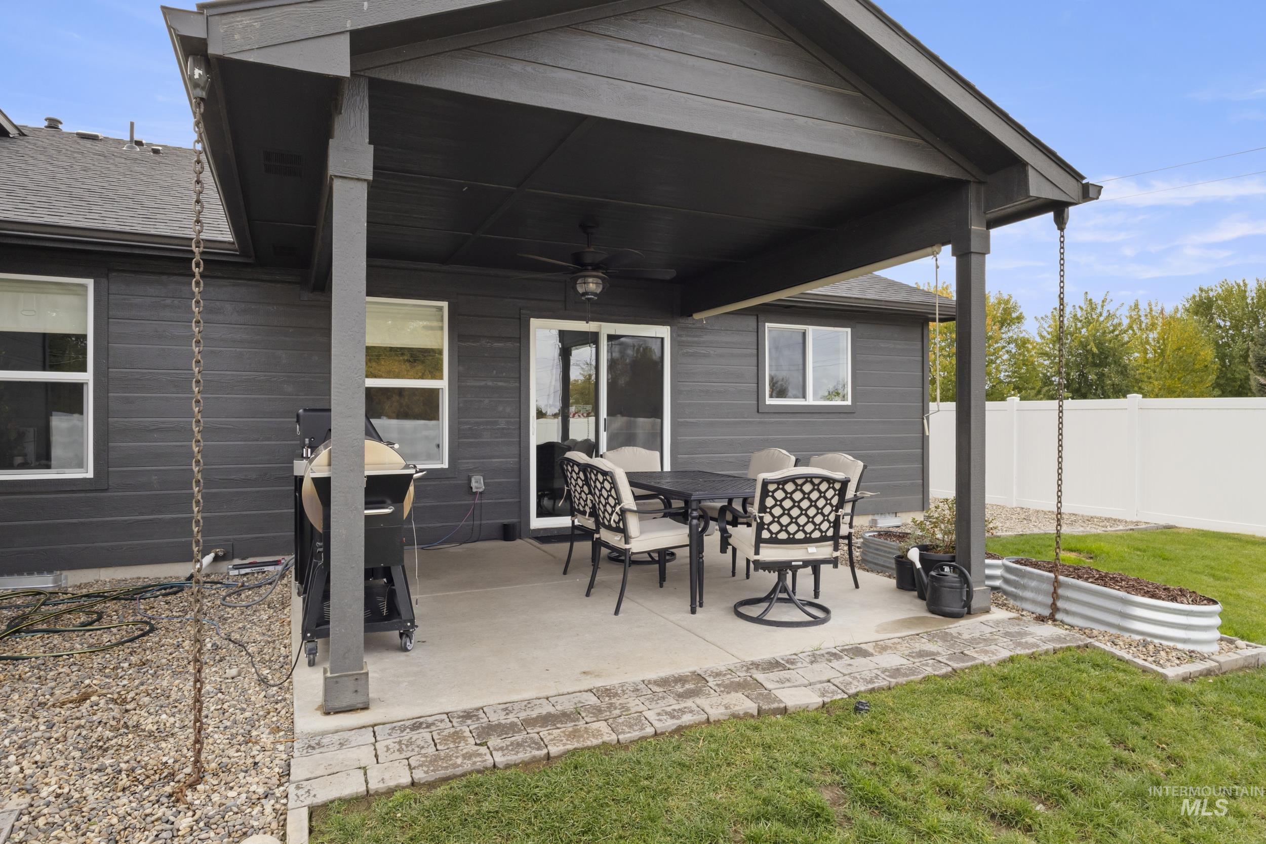 View of patio with a ceiling fan and a grill