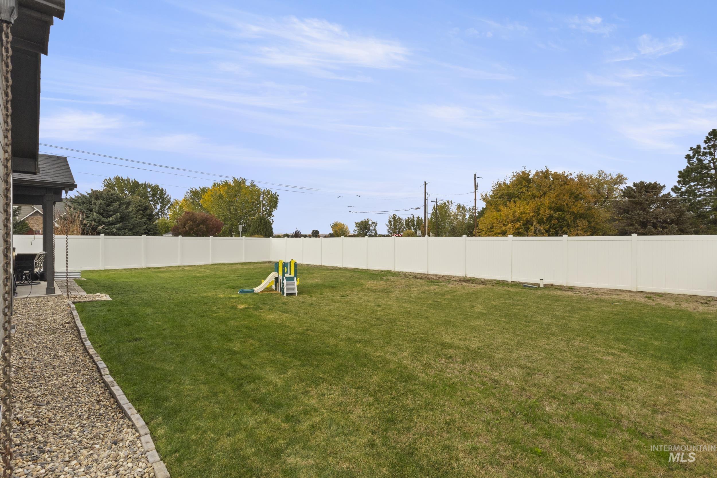 Fenced backyard with a patio