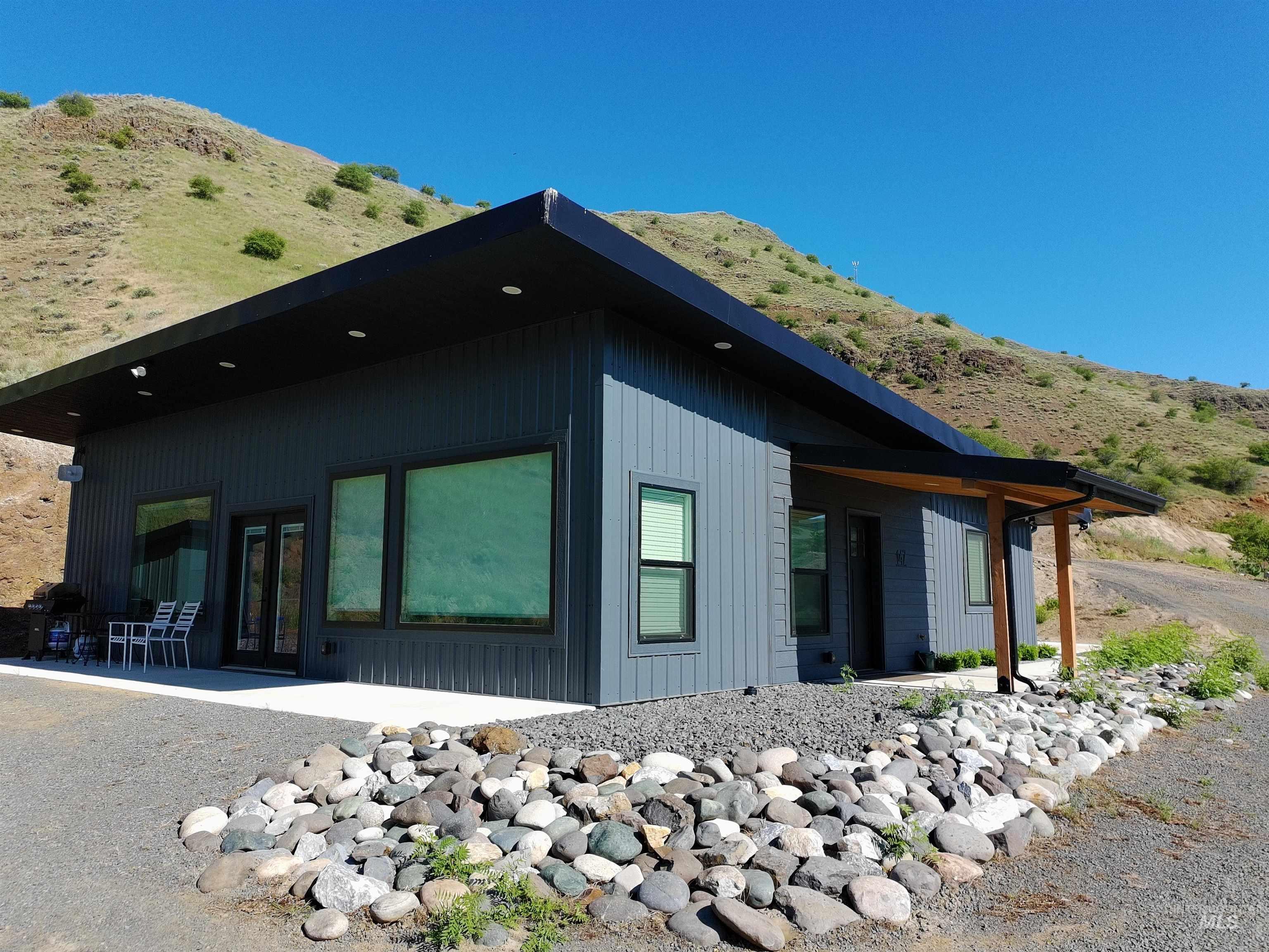View of home's exterior with a patio area and a mountain view