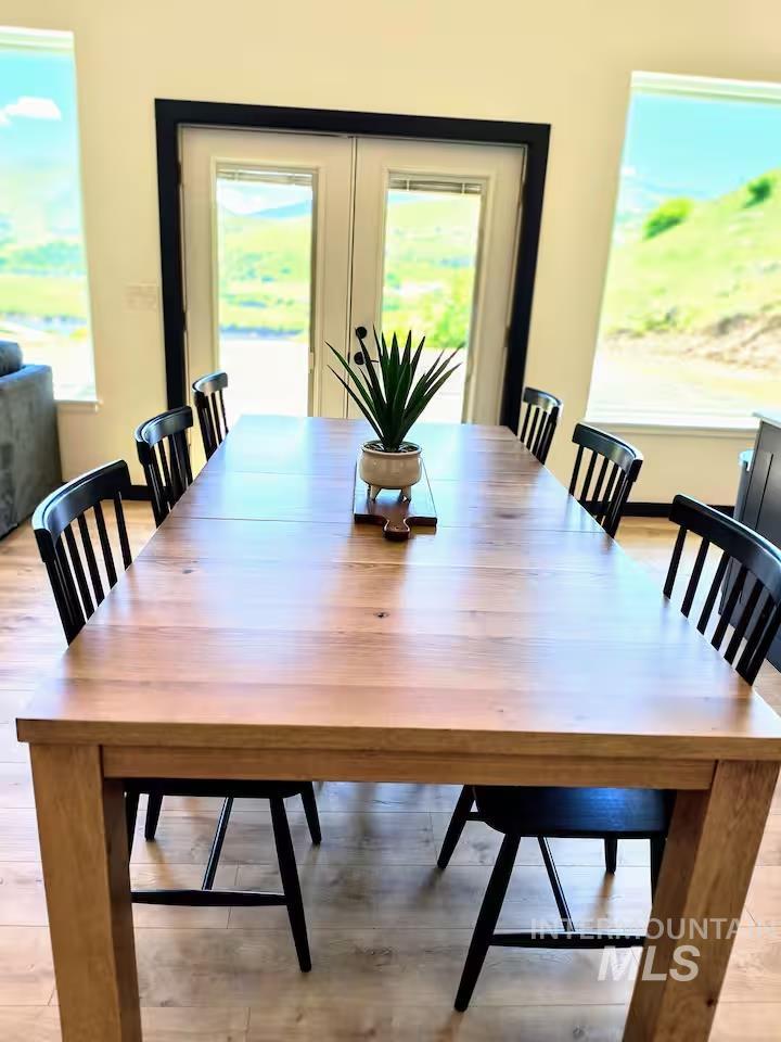 Dining space featuring healthy amount of natural light and light wood-style flooring