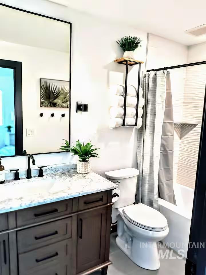 Full bathroom featuring shower / tub combo, vanity, and light tile patterned flooring