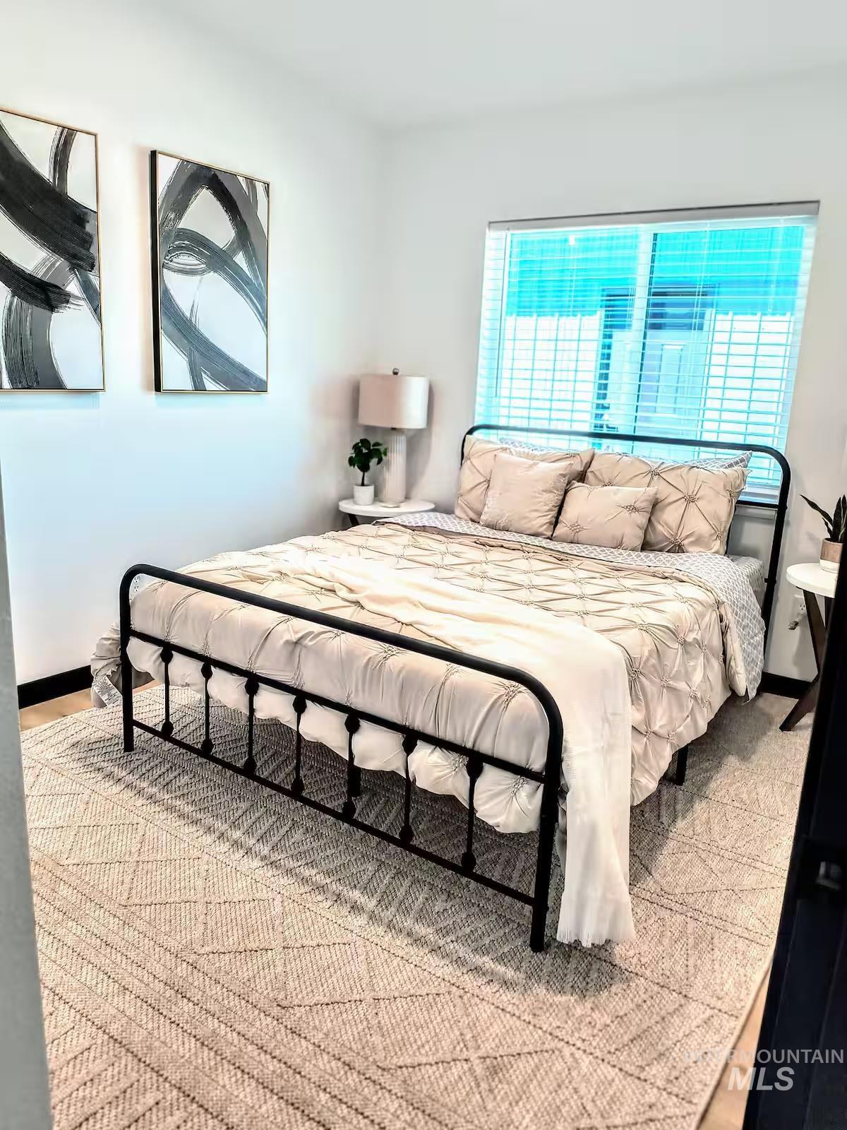 Bedroom #3 with light wood finished floors and baseboards