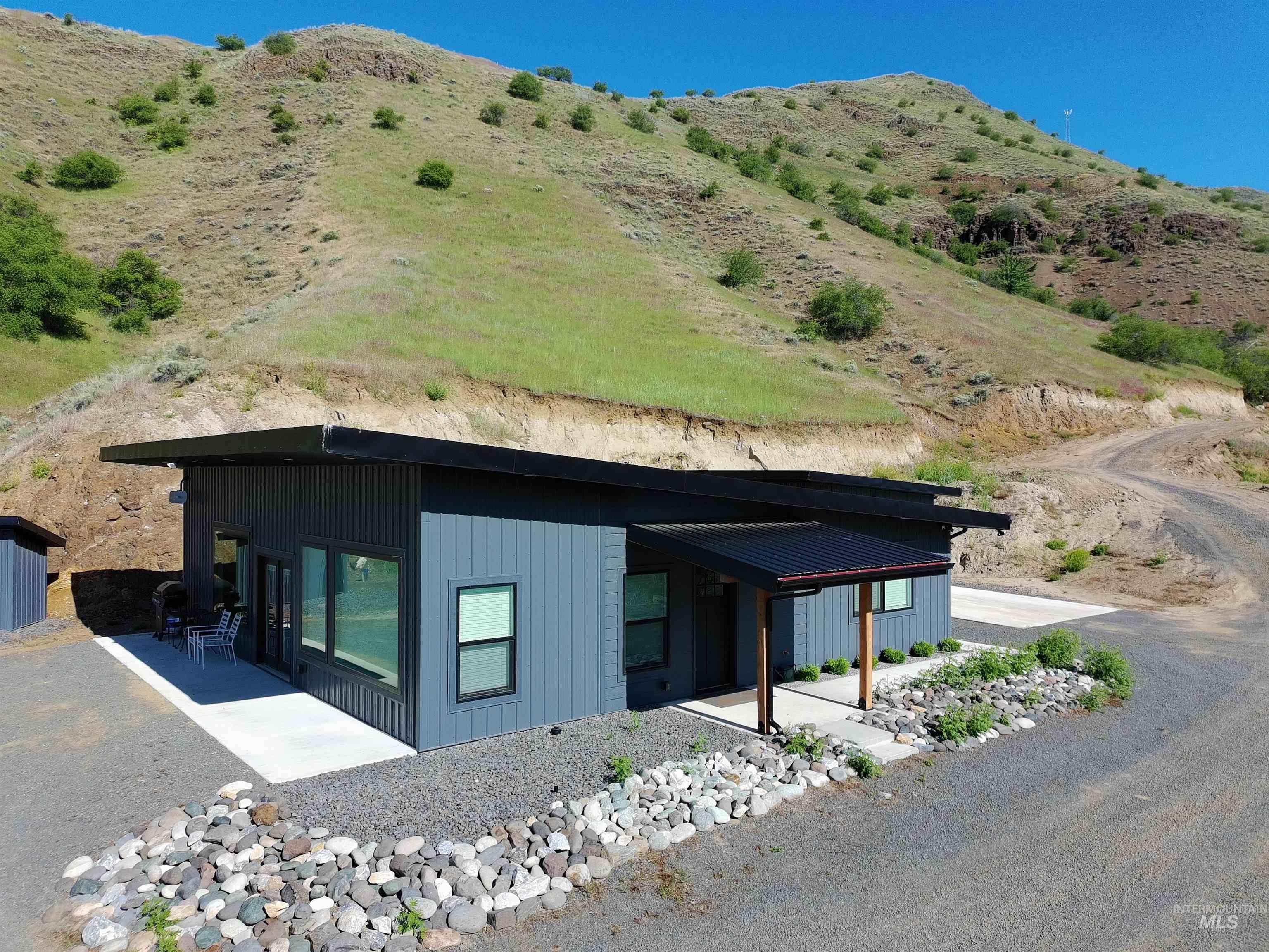 View of side of property featuring a patio area and a mountain view
