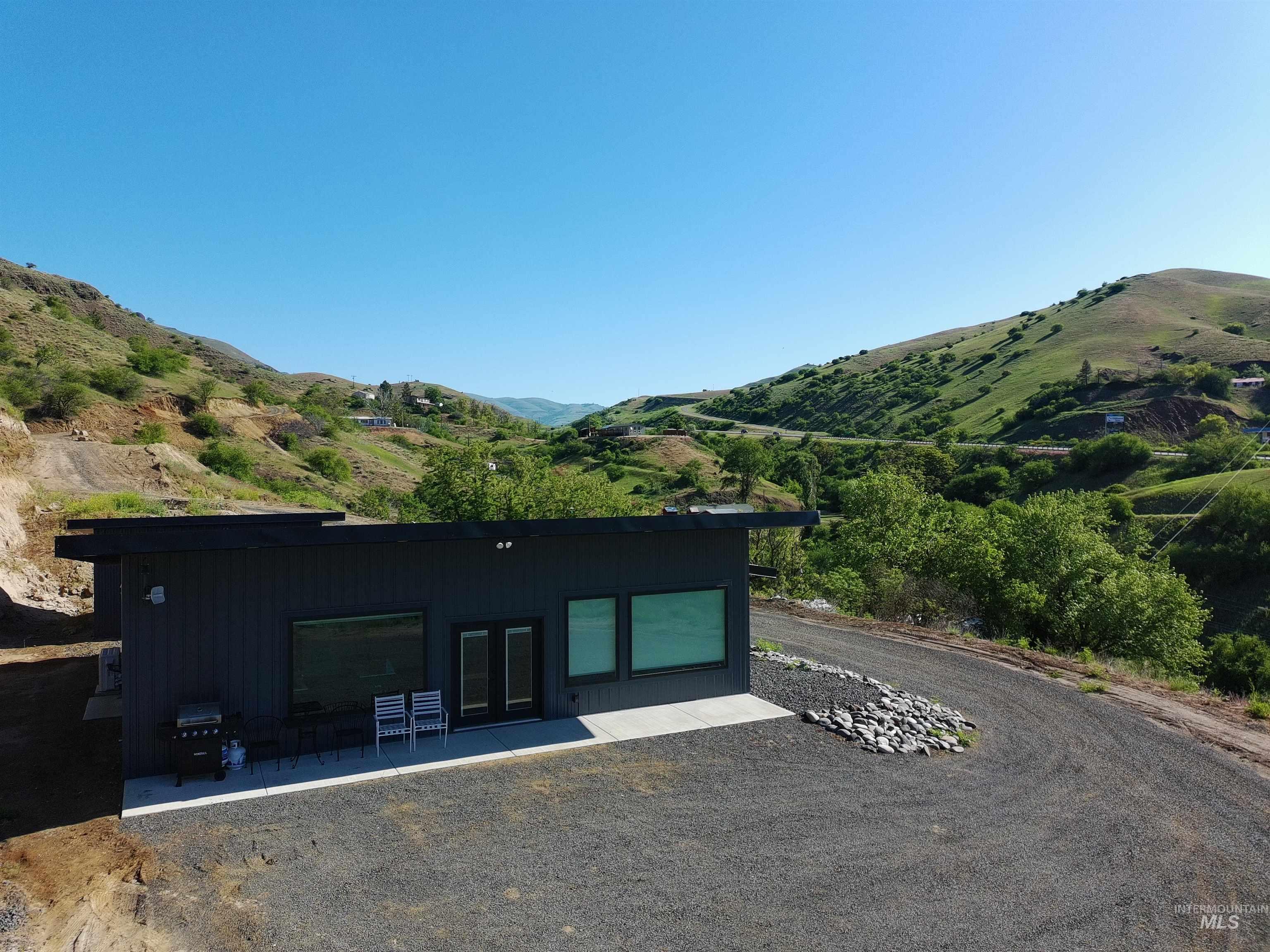 View of front of property with a mountain view, french doors, and a patio