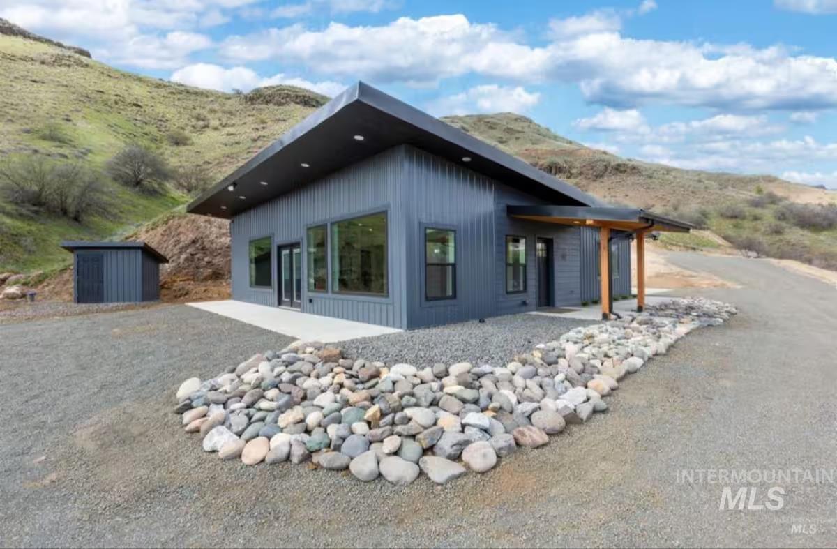View of side of home with a patio and a mountain view