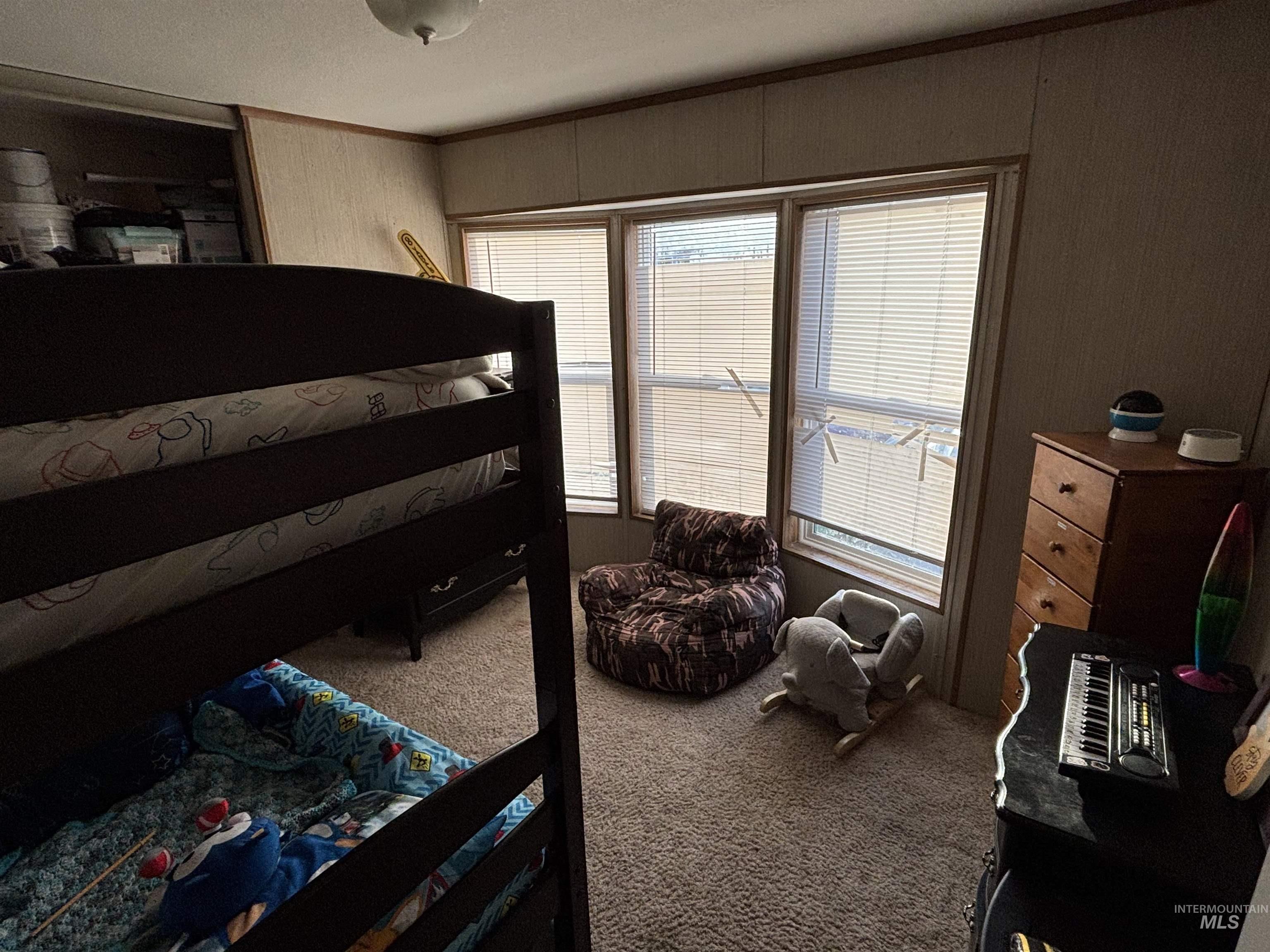 Bedroom featuring carpet flooring and crown molding