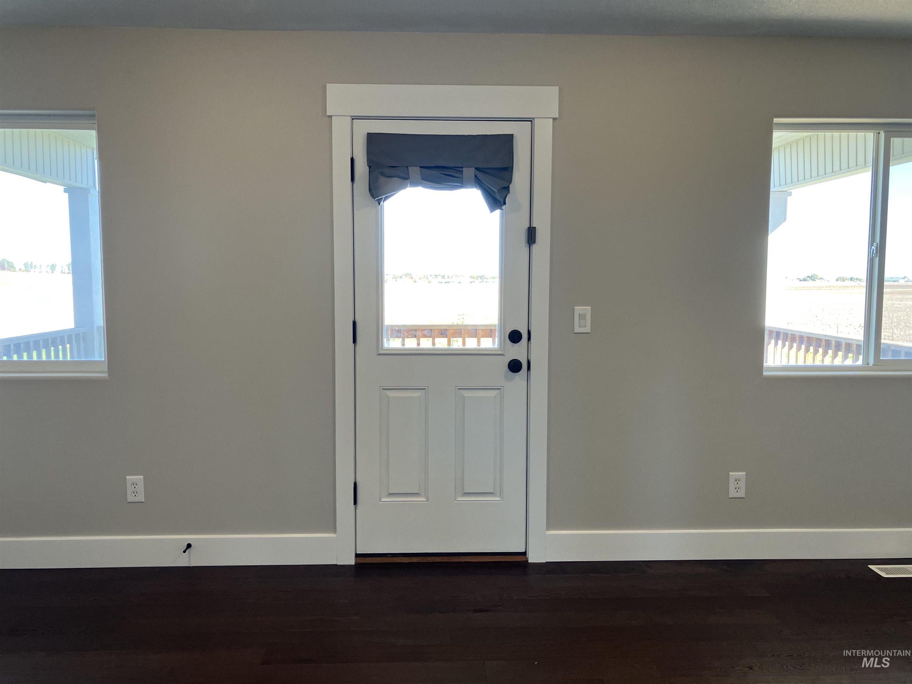 Bedroom featuring plenty of natural light and dark wood-type flooring with access to a balcony deck and a 8' x 19' 