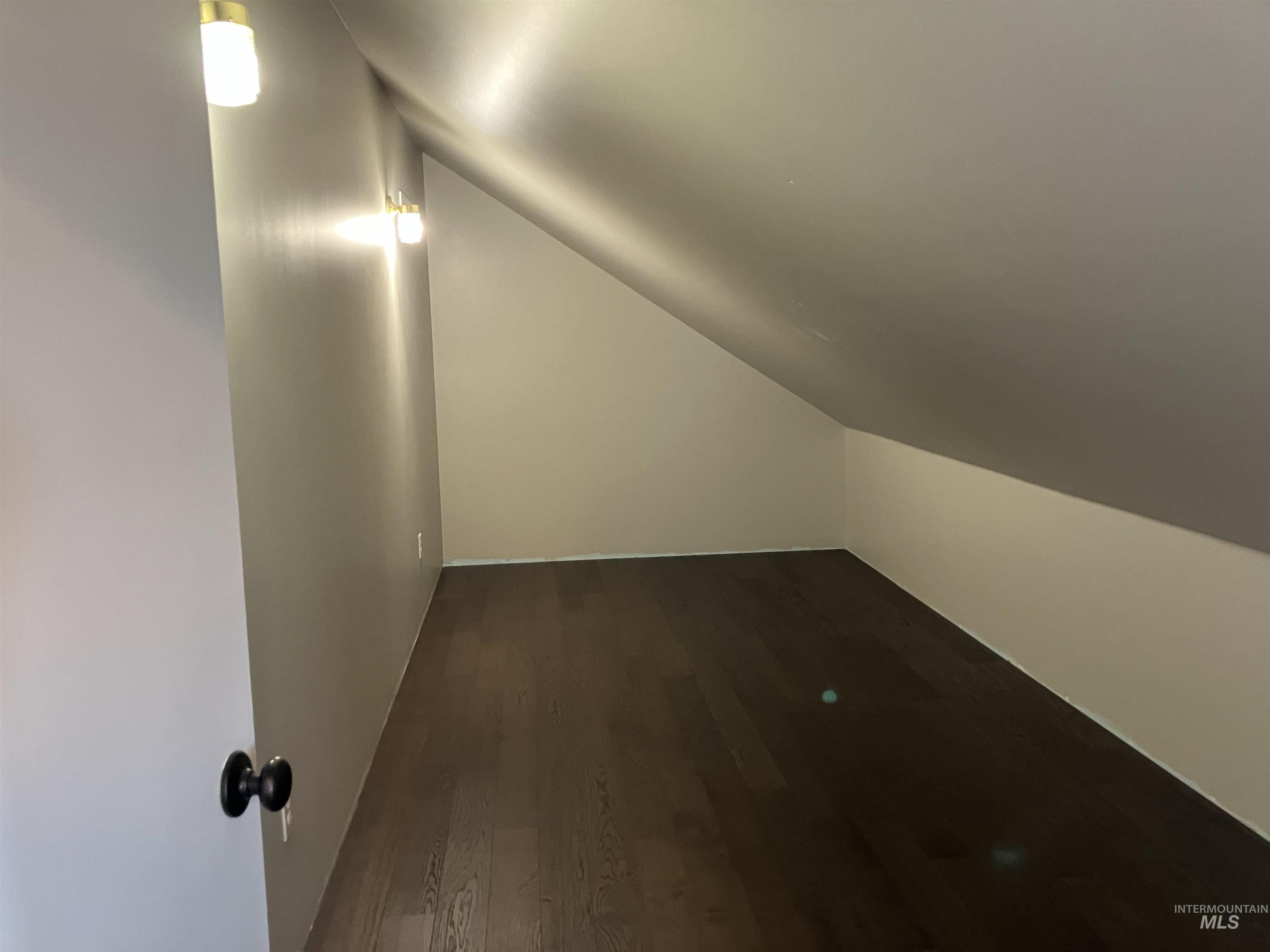 Closet with dark wood-style flooring and lofted ceiling.  Floor is 8' x 19'