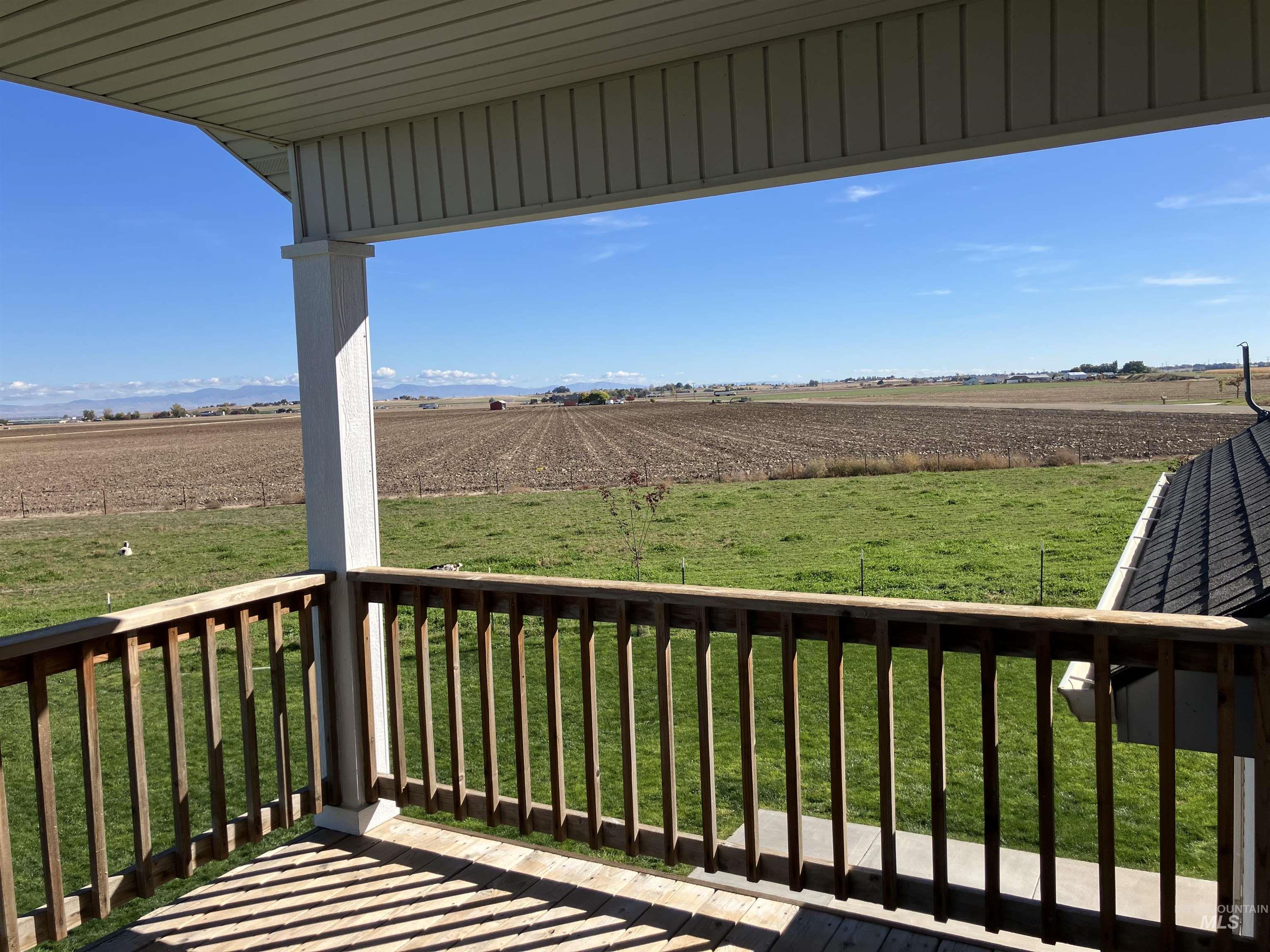 Balcony featuring a yard, a view of rural / pastoral area, and agricultural area from upper bedroom